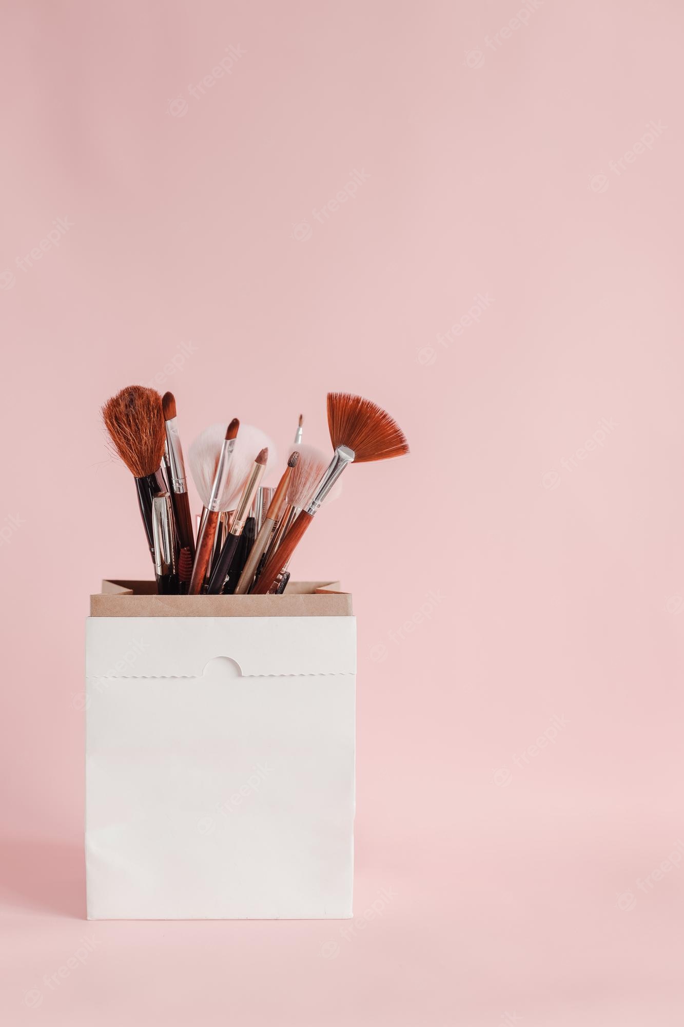 Premium Photo. Beauty products on white paper bag for mock up branding with copy space cute girly wallpaper
