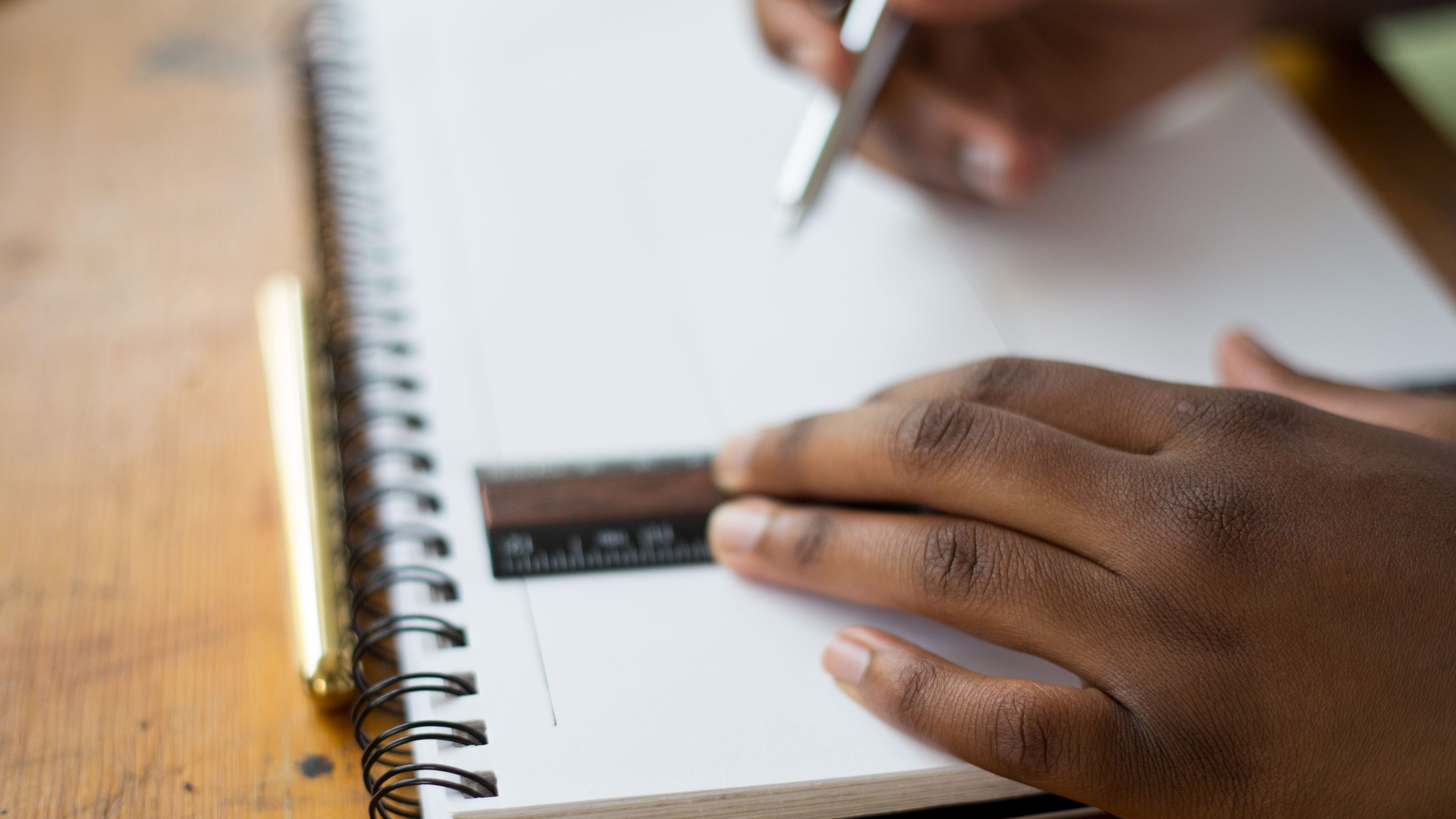 Wallpaper / a person drawing in a notepad with a ruler, precise drawing 4k wallpaper free download