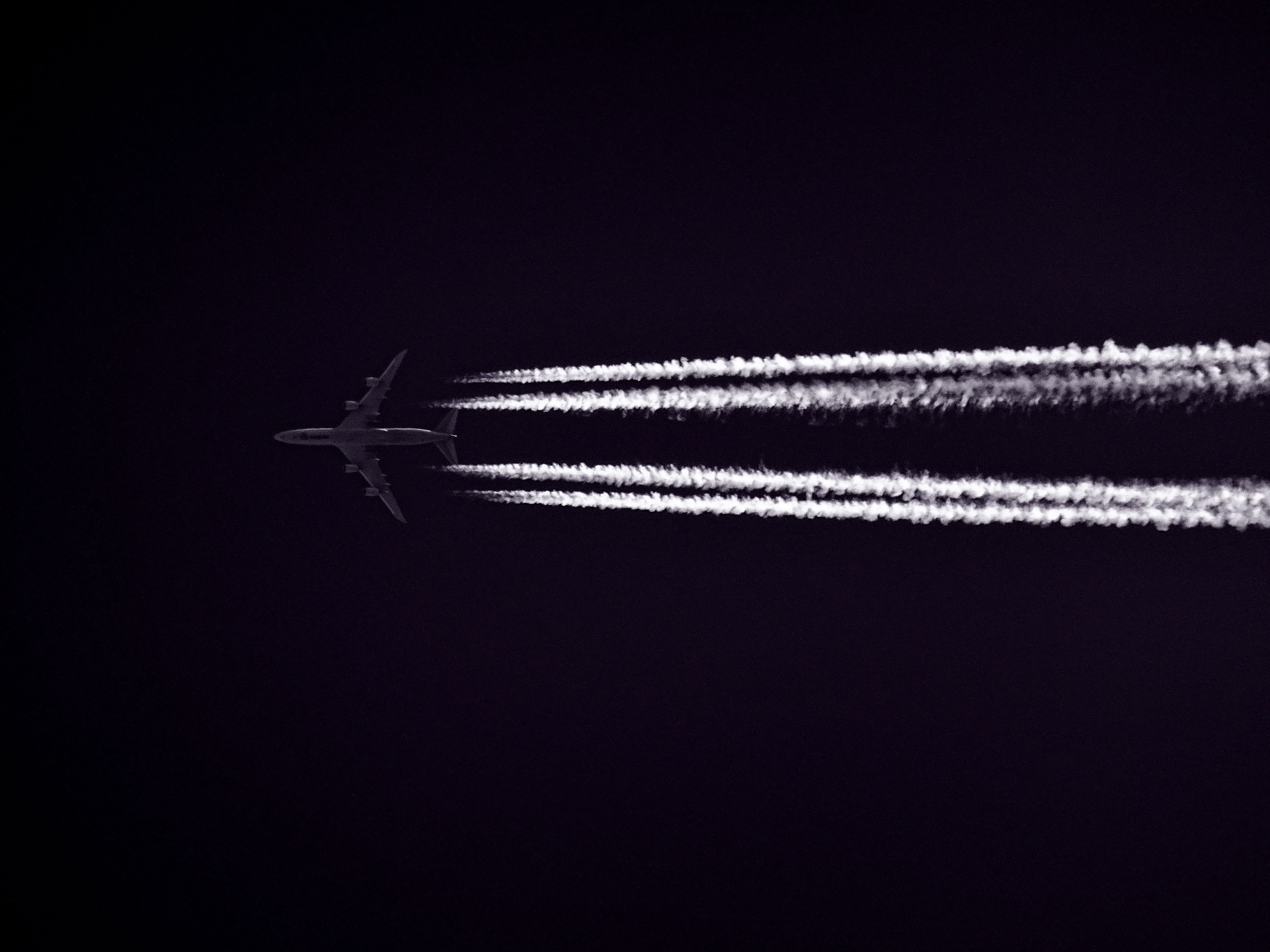 Photo of Airplane Across the Clouds during Night Time · Free