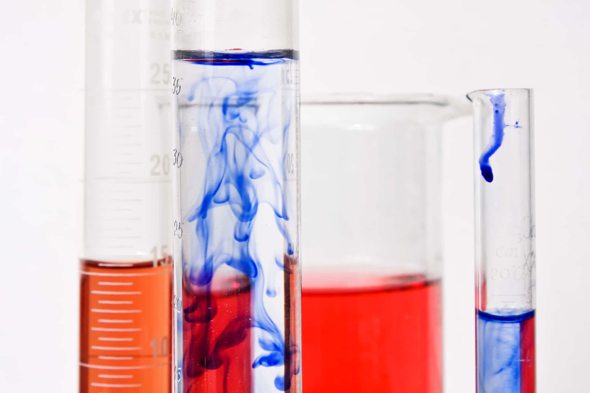 Download A Group Of Test Tubes With Blue And Red Liquids Wallpaper