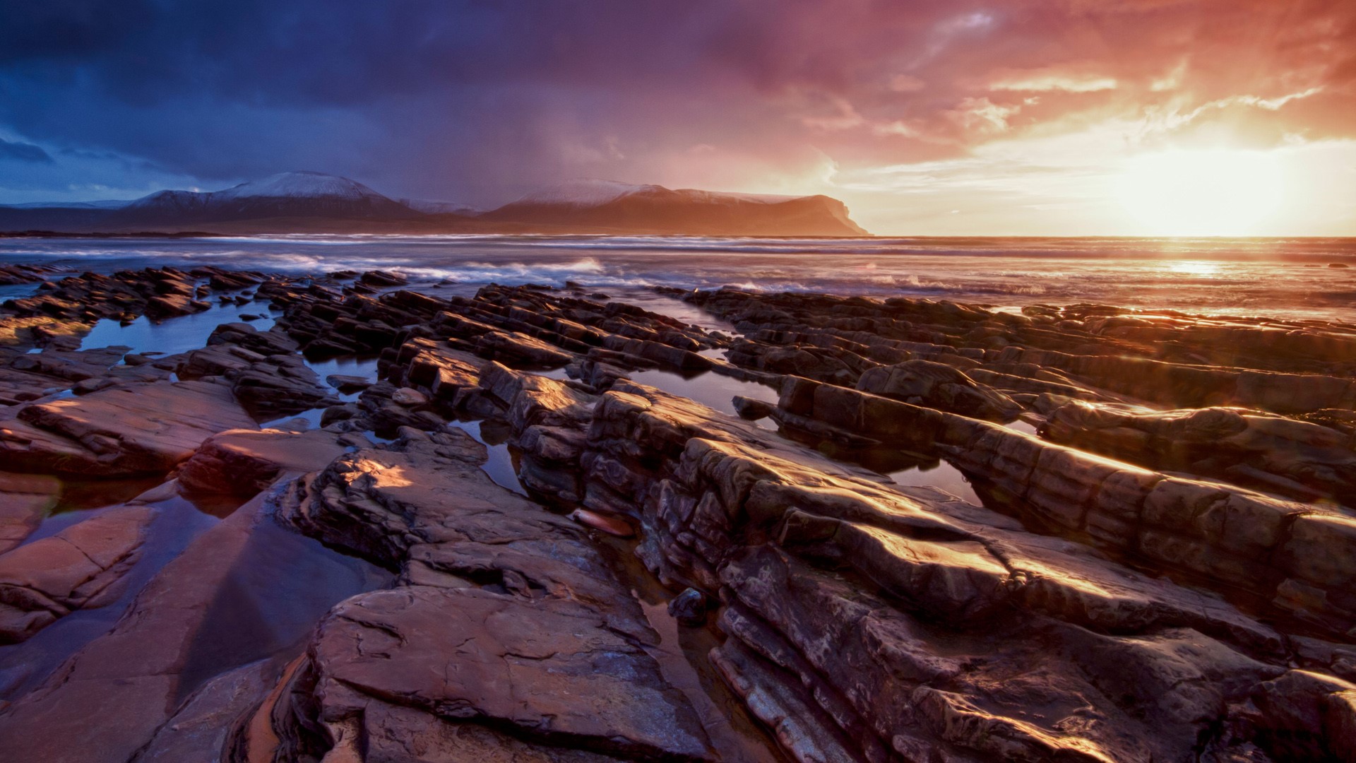 Winter sunset at rocky Warebeth beach, Orkney Islands, Scotland, UK. Windows 10 Spotlight Image