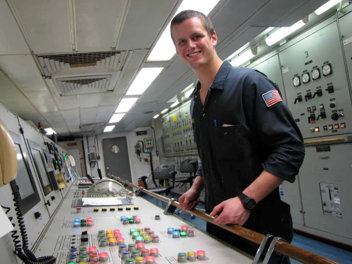 Download A Man Standing In A Control Room
