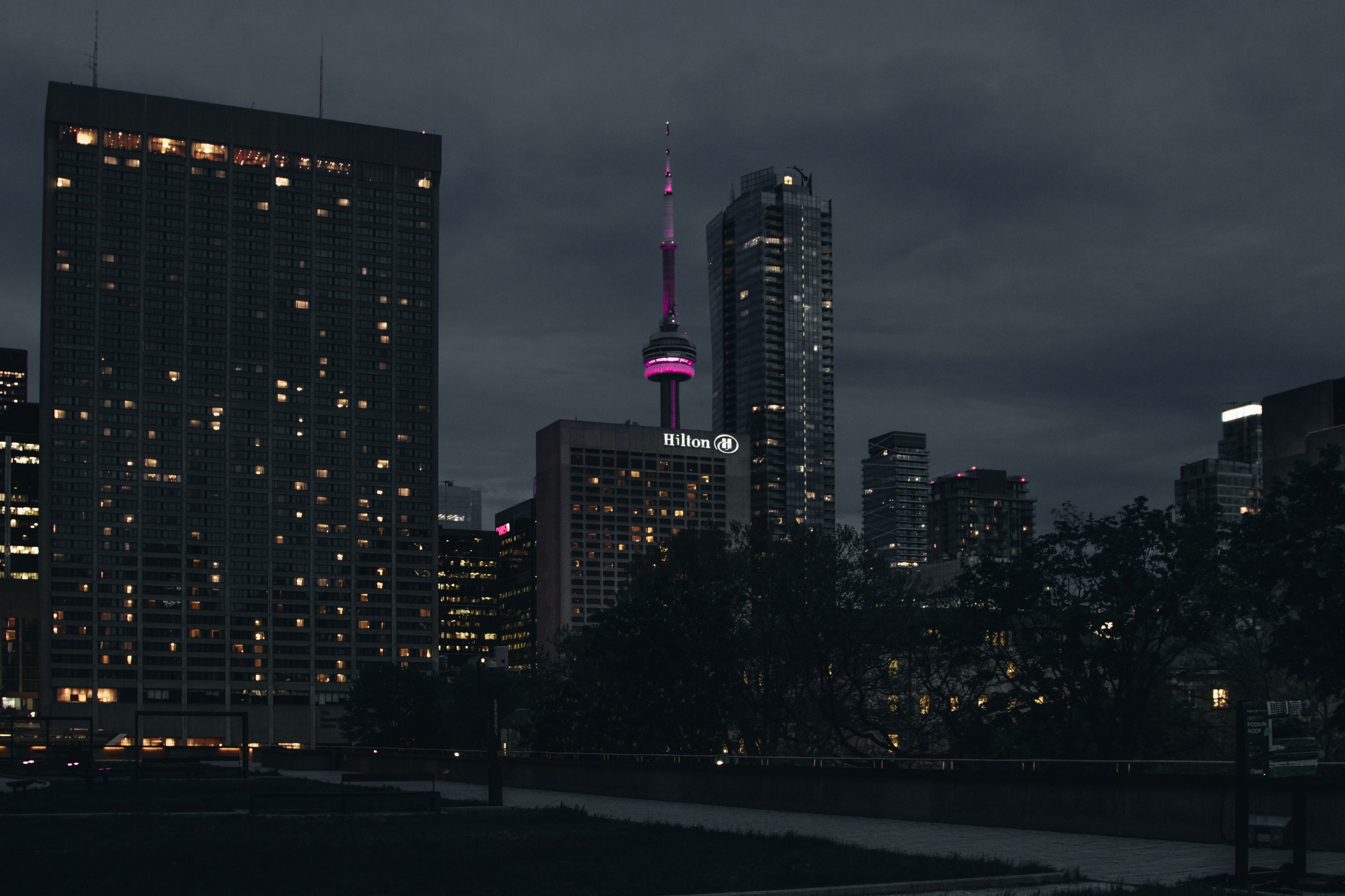 Wallpaper / a dim cityscape of toronto with the cn tower lit up in purple, toronto night cityscape 4k wallpaper free download