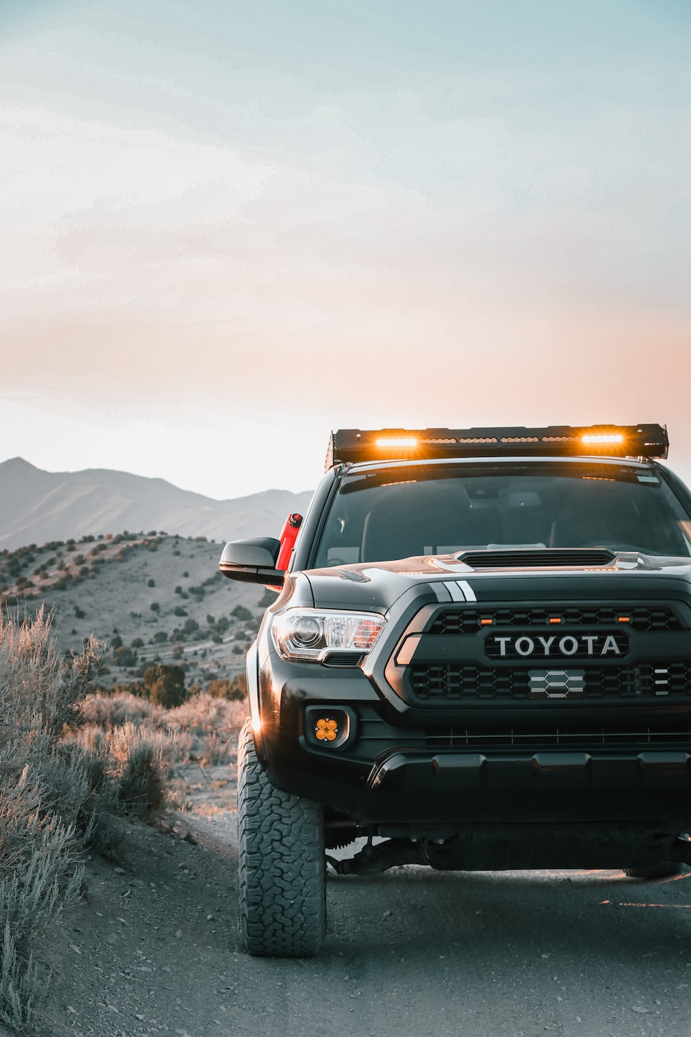 A toyota truck is parked on a dirt road photo