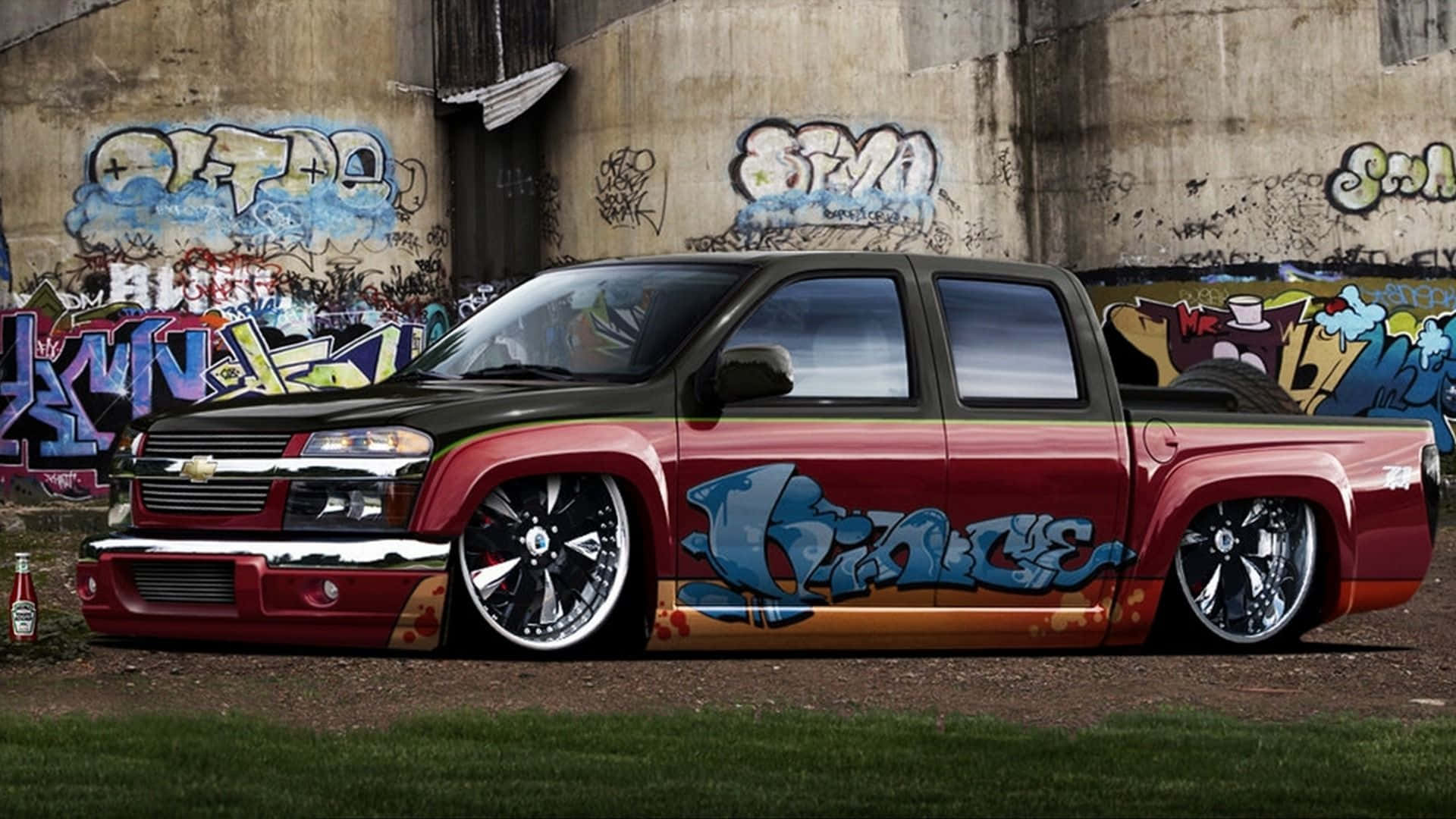 Download A Red And Black Truck With Graffiti On It Wallpaper