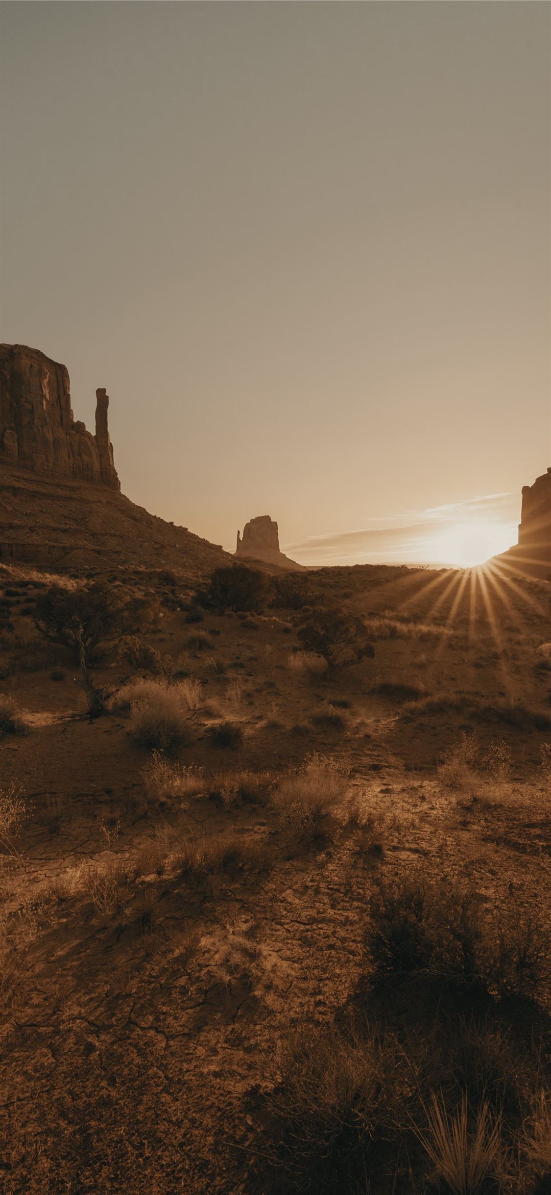 brown rock formation under white sky during daytim. iPhone X Wallpaper Free Download