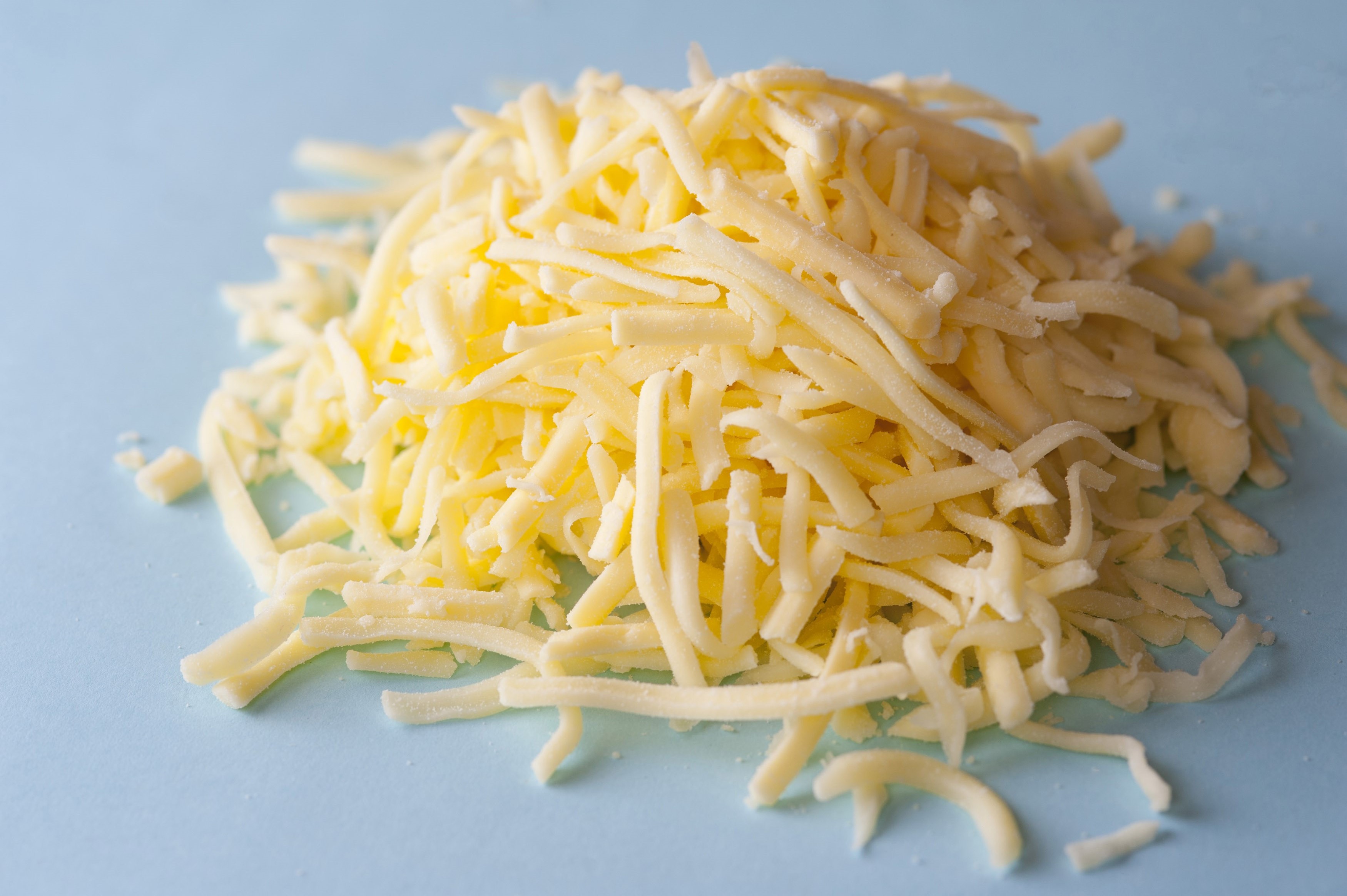 Grated cheddar cheese Stock Image