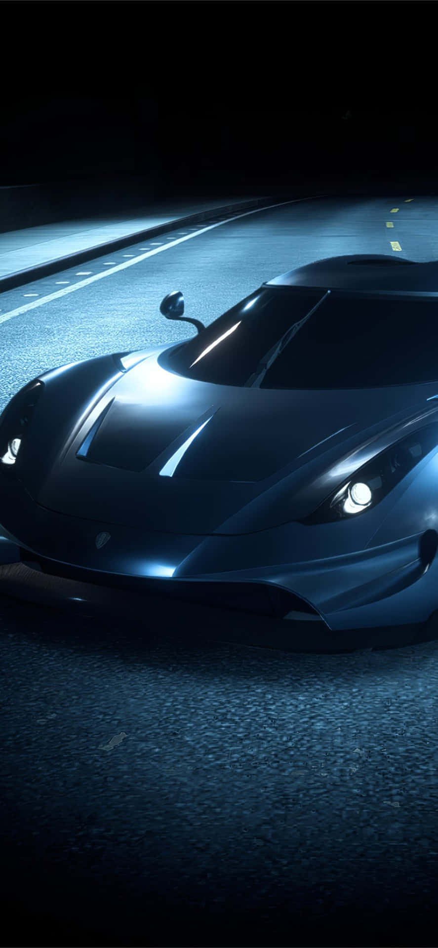 Download A Blue Sports Car Driving Down The Road At Night Wallpaper