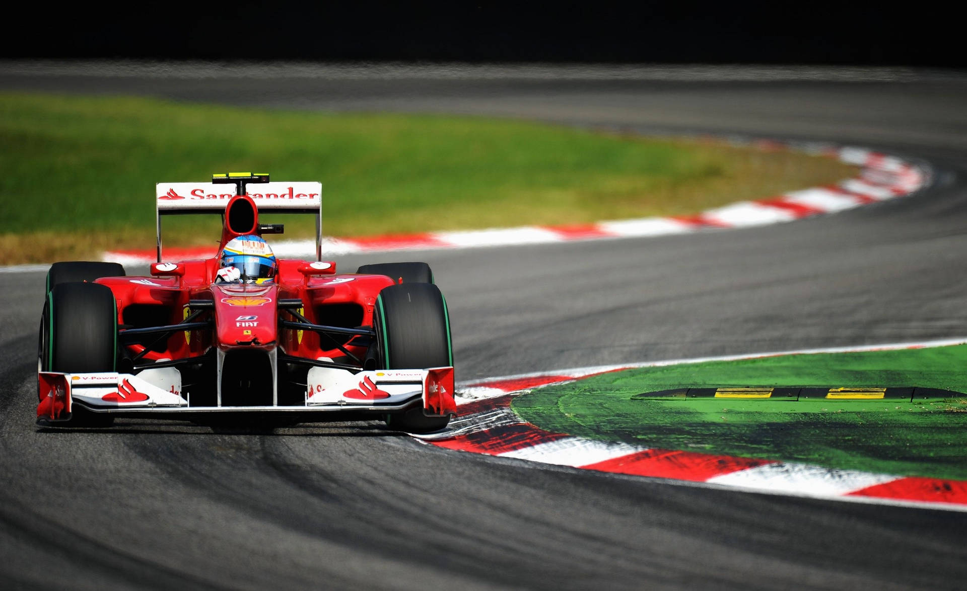 Download Ferrari F1 Car Driving Down A Track Wallpaper