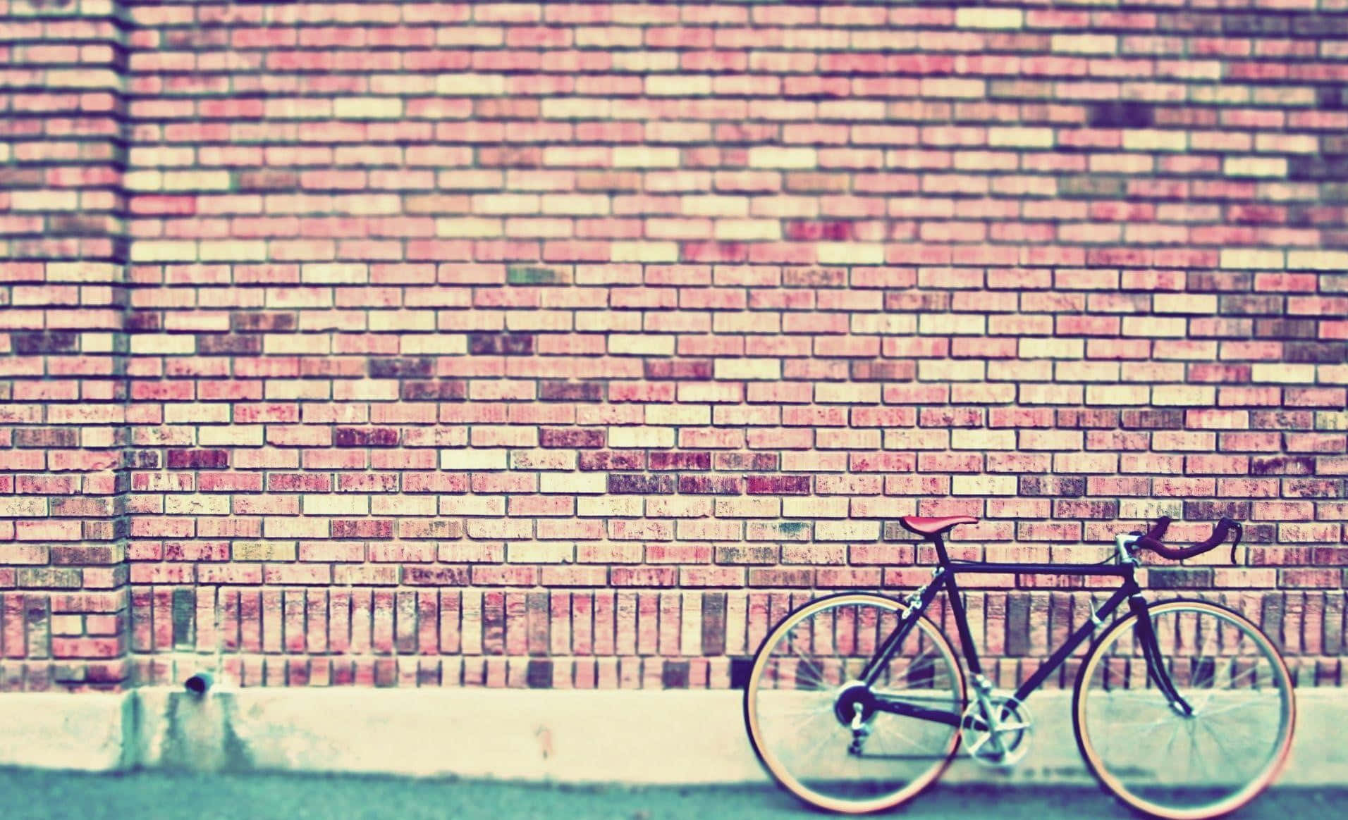 Download A Bicycle Leaning Against A Brick Wall Wallpaper