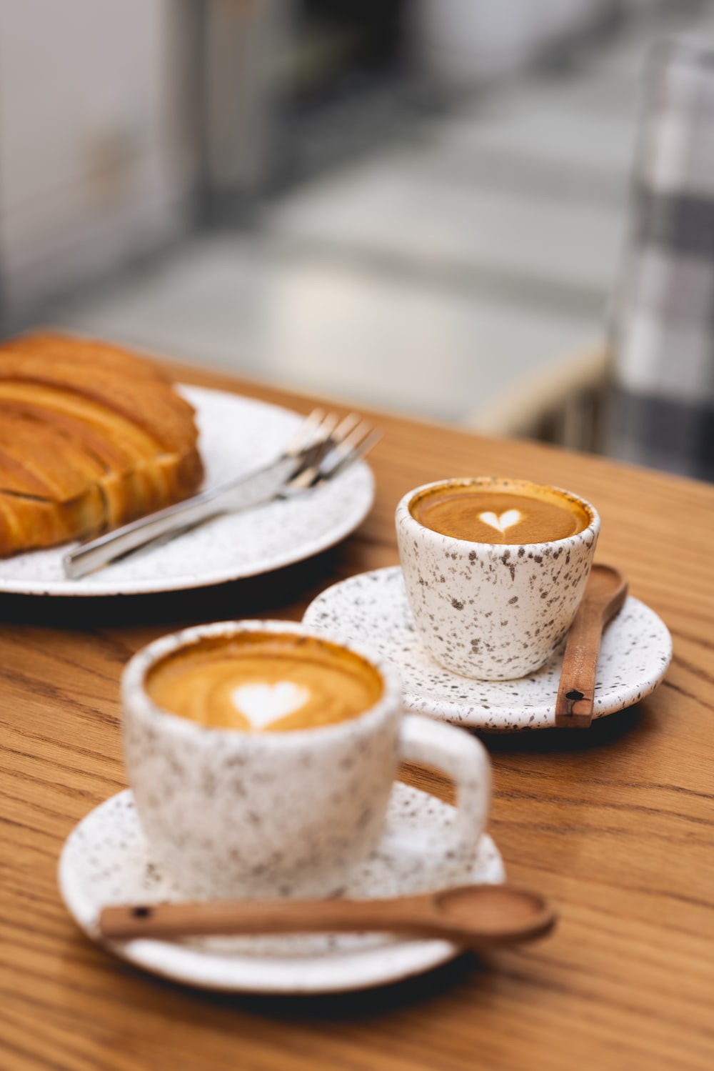 A table topped with two cups of coffee photo
