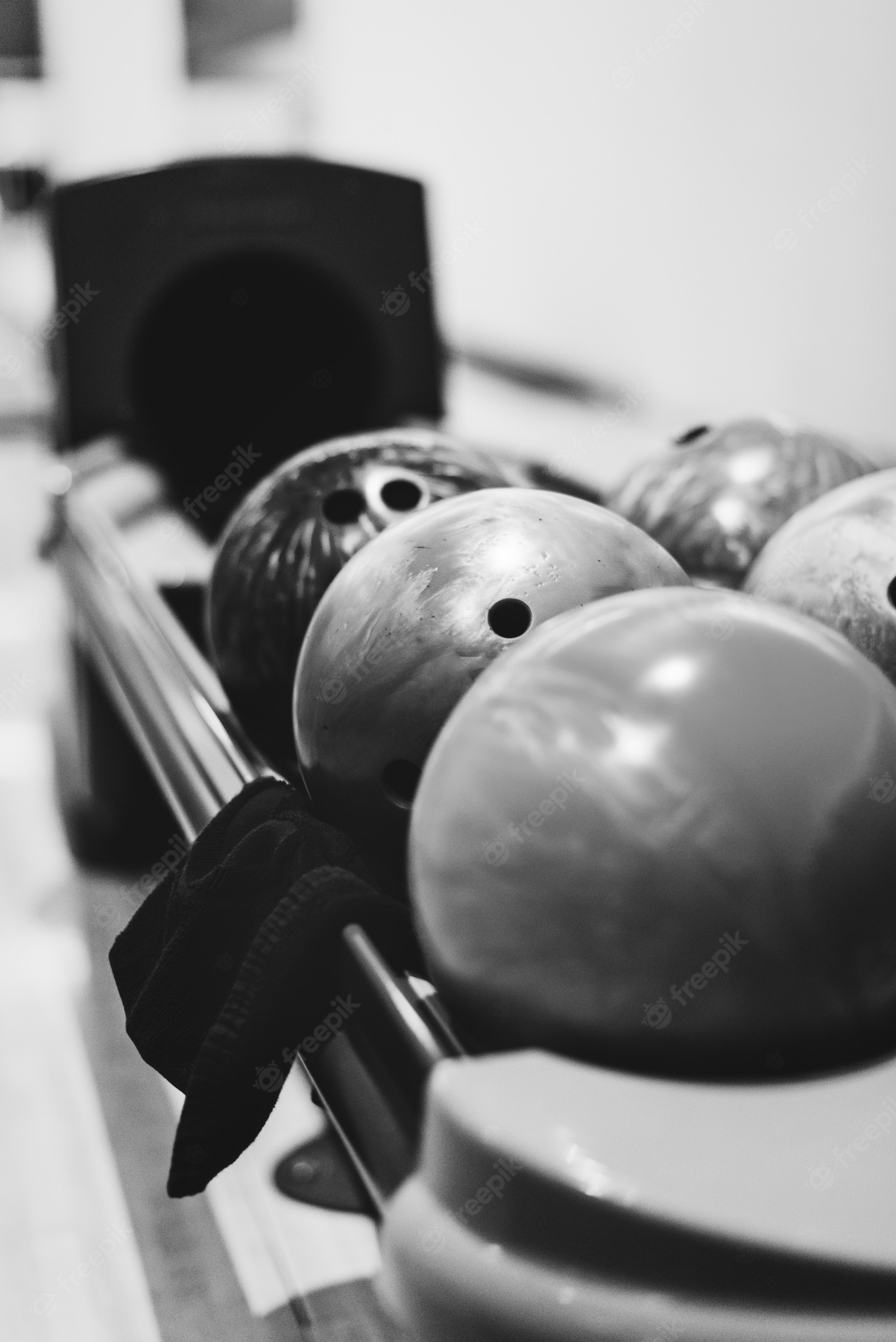 Free Photo. Bowling balls lined at the bowling alley