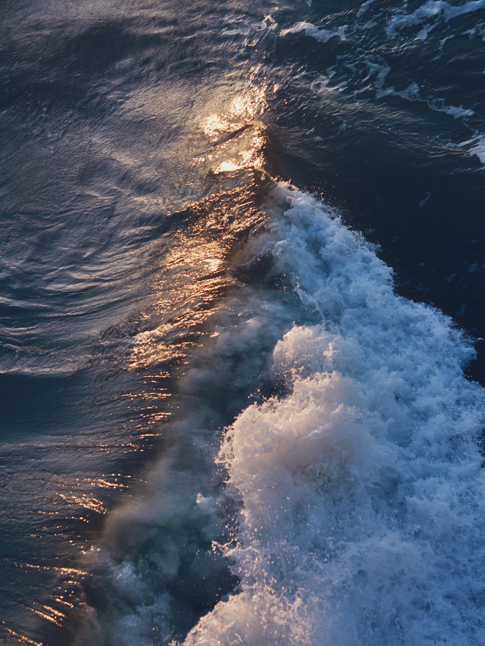 The wake of a boat in the ocean photo
