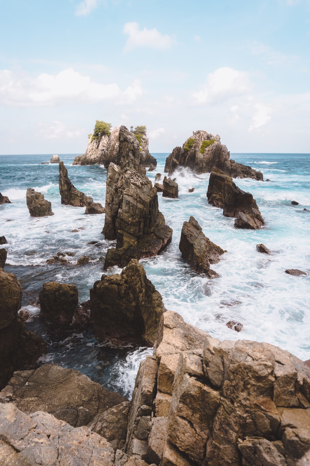 Time Lapse Photography Of Rock Formations By The Sea Under Cloudy Sky Photo