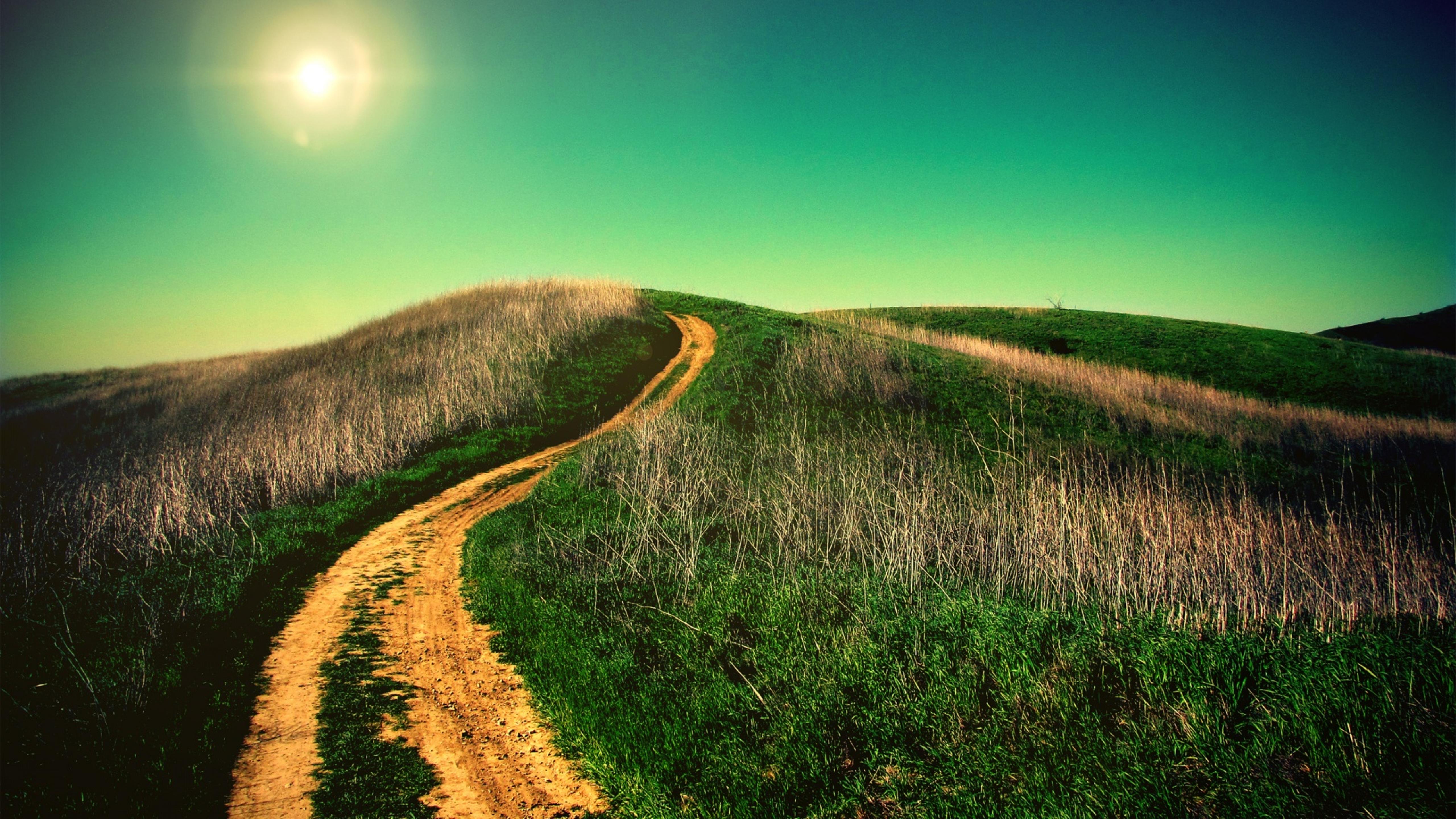 Country road goes on the top of the hill