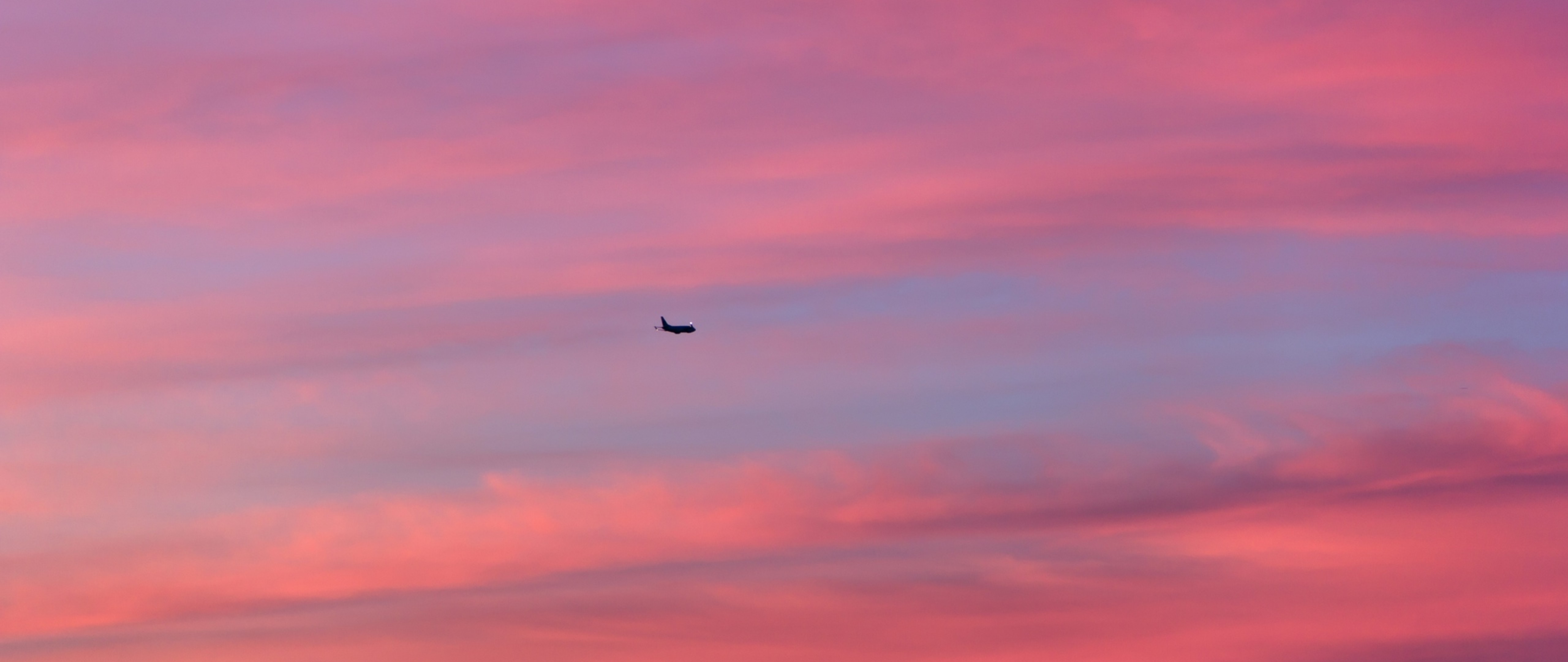 Plane flying over a pink sky HD Wallpaper 4K Ultra HD Wide TV