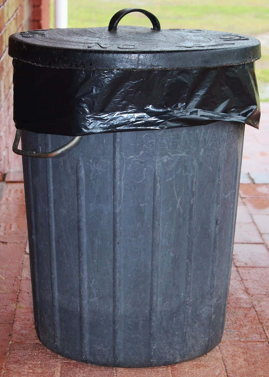 Download Black Plastic Barrel Trash Can With Lid Wallpaper