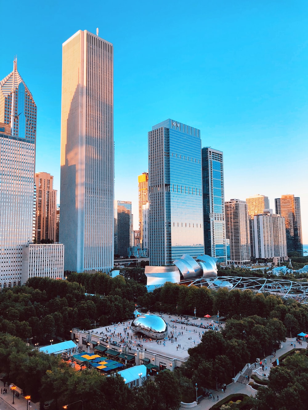 People gathering on cloud gate, chicago, illinois near buildings photo