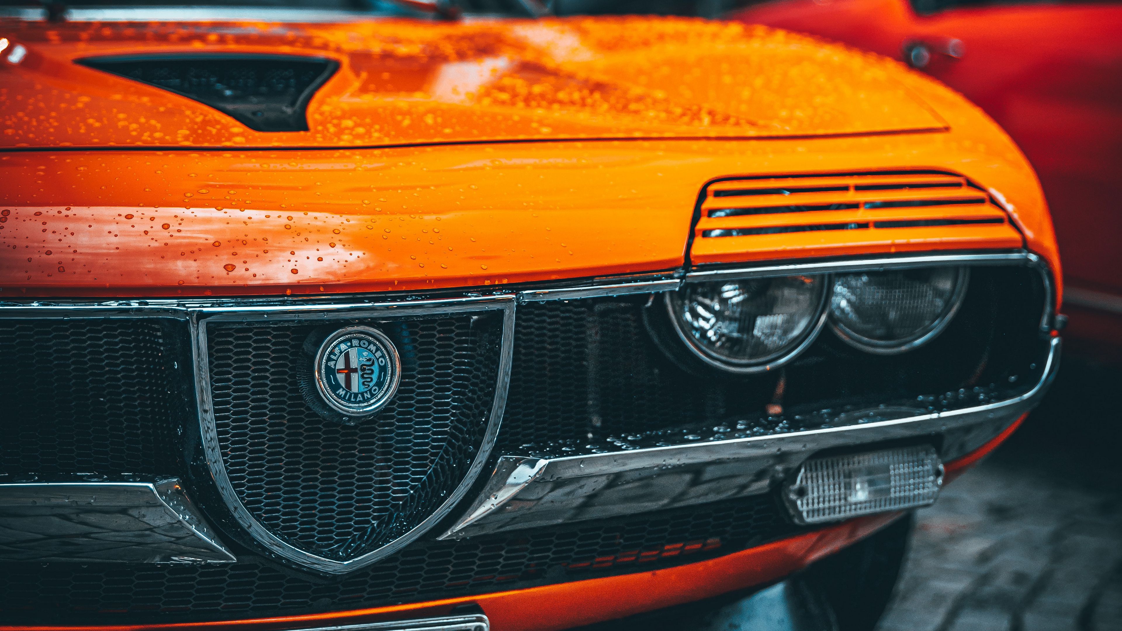 Download wallpaper 3840x2160 alfa romeo, car, orange, wet, front view 4k uhd 16:9 HD background