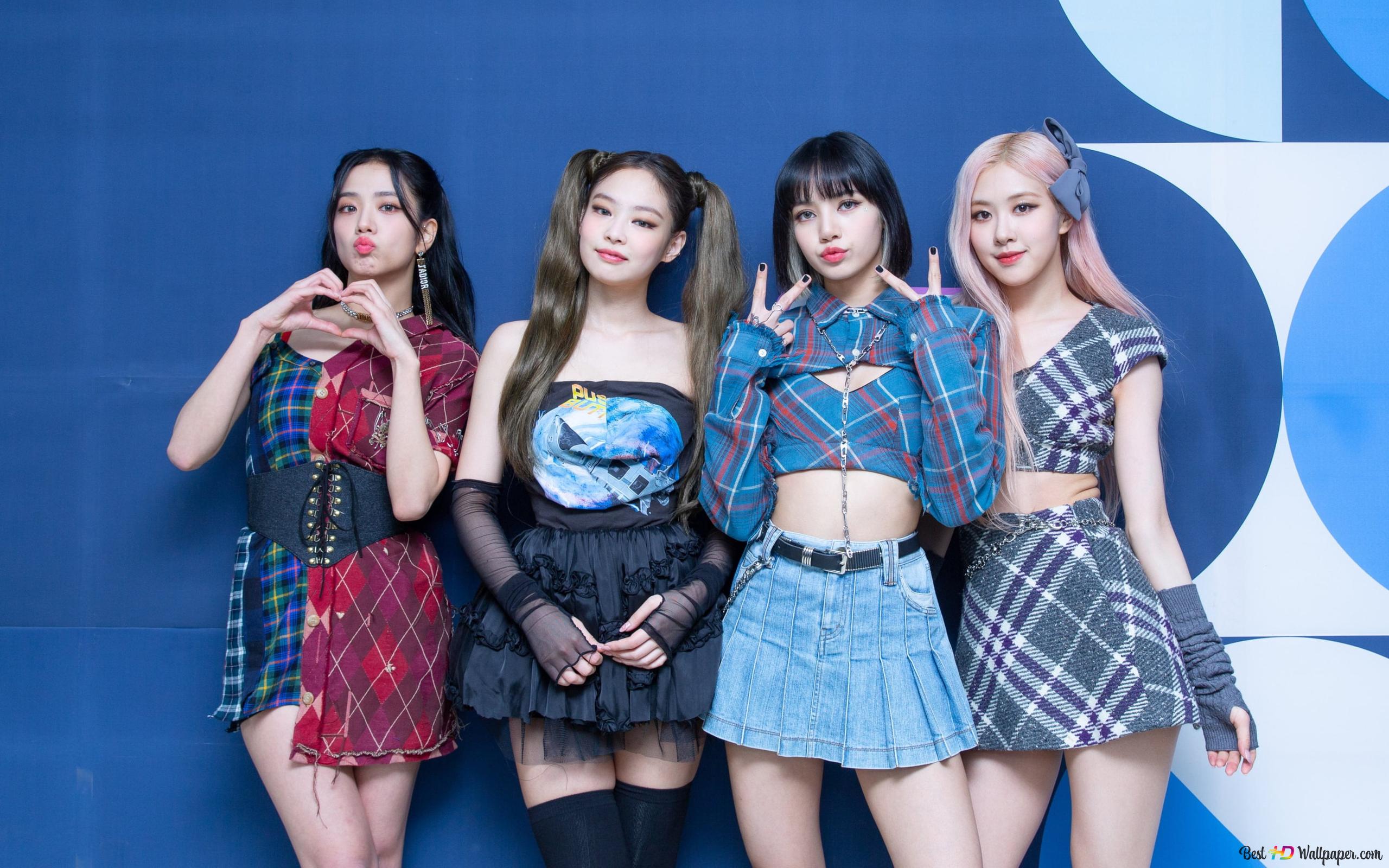 South Korean girl group members pose in colorful outfits in front of a blue background 2K wallpaper download