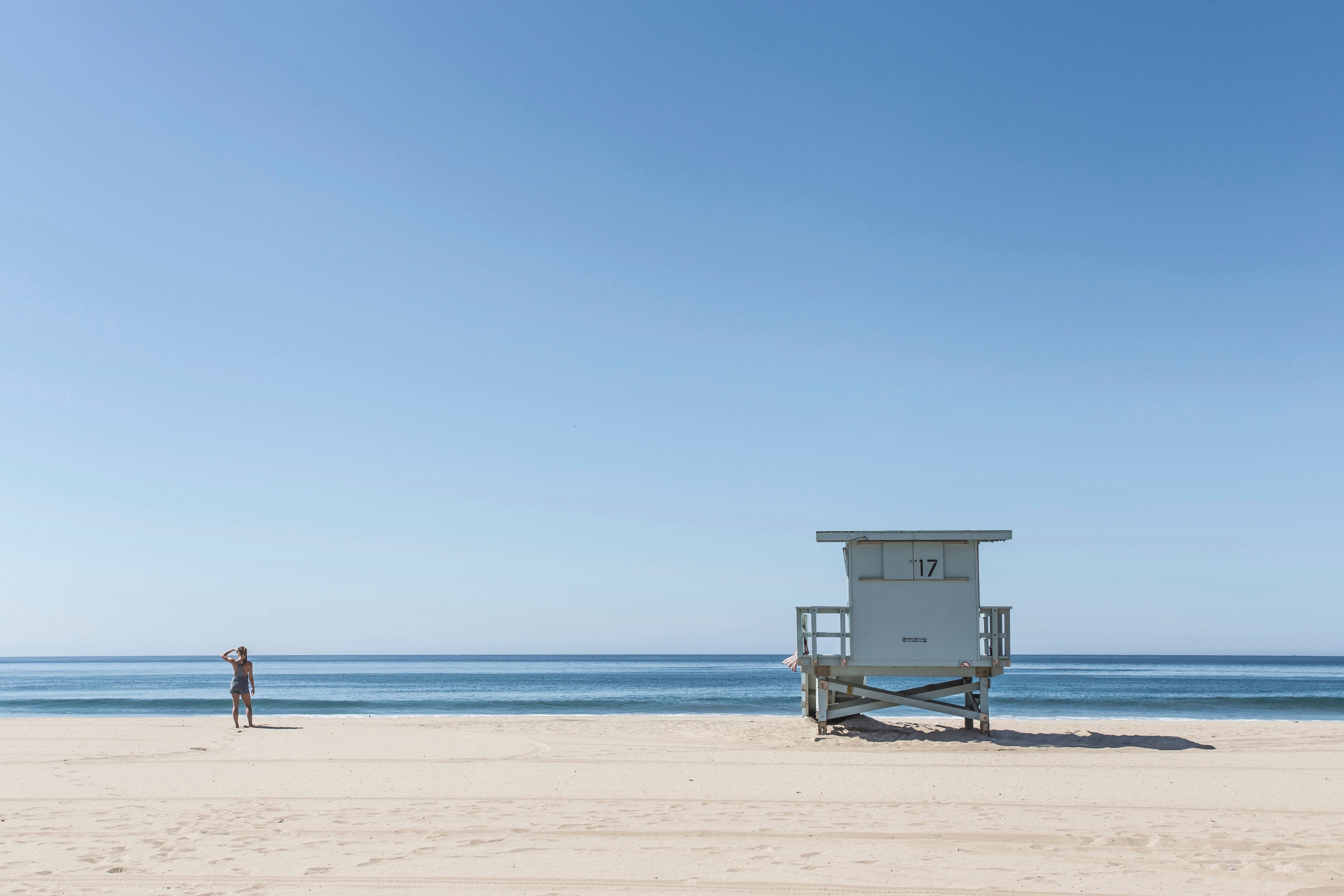 Wallpaper / lifeguard stand in tranquil beach photo of ocean and shoreline in a summer day, beach at los angeles california united states 4k wallpaper free download