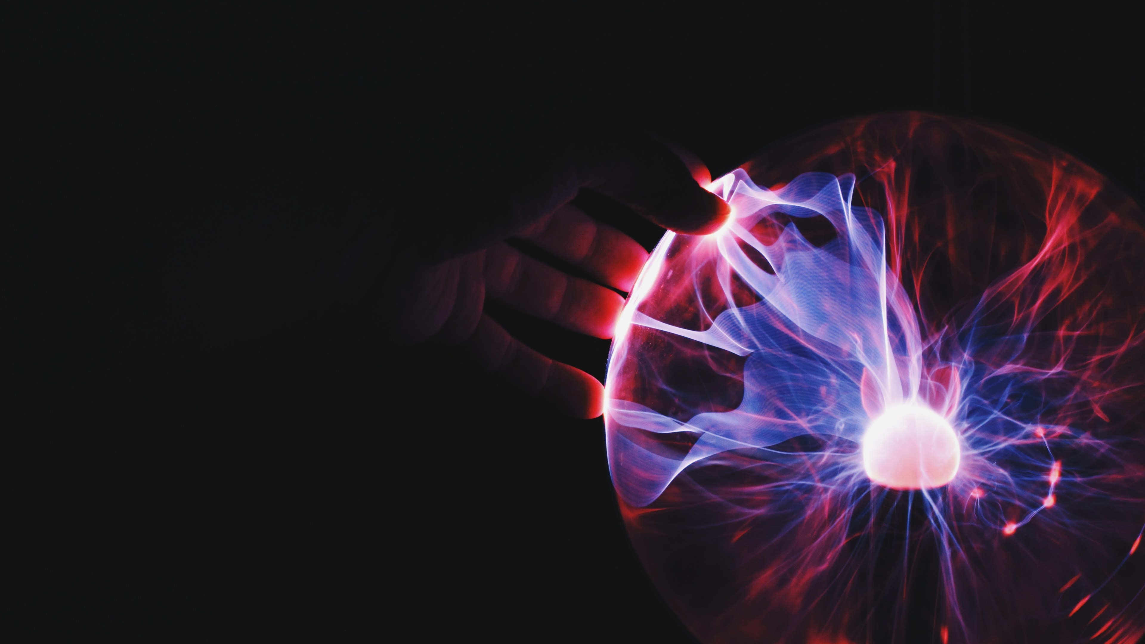 a hand touching an orb pulsating