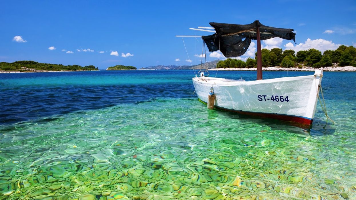 Yacht boat stones sea beaches sky blue