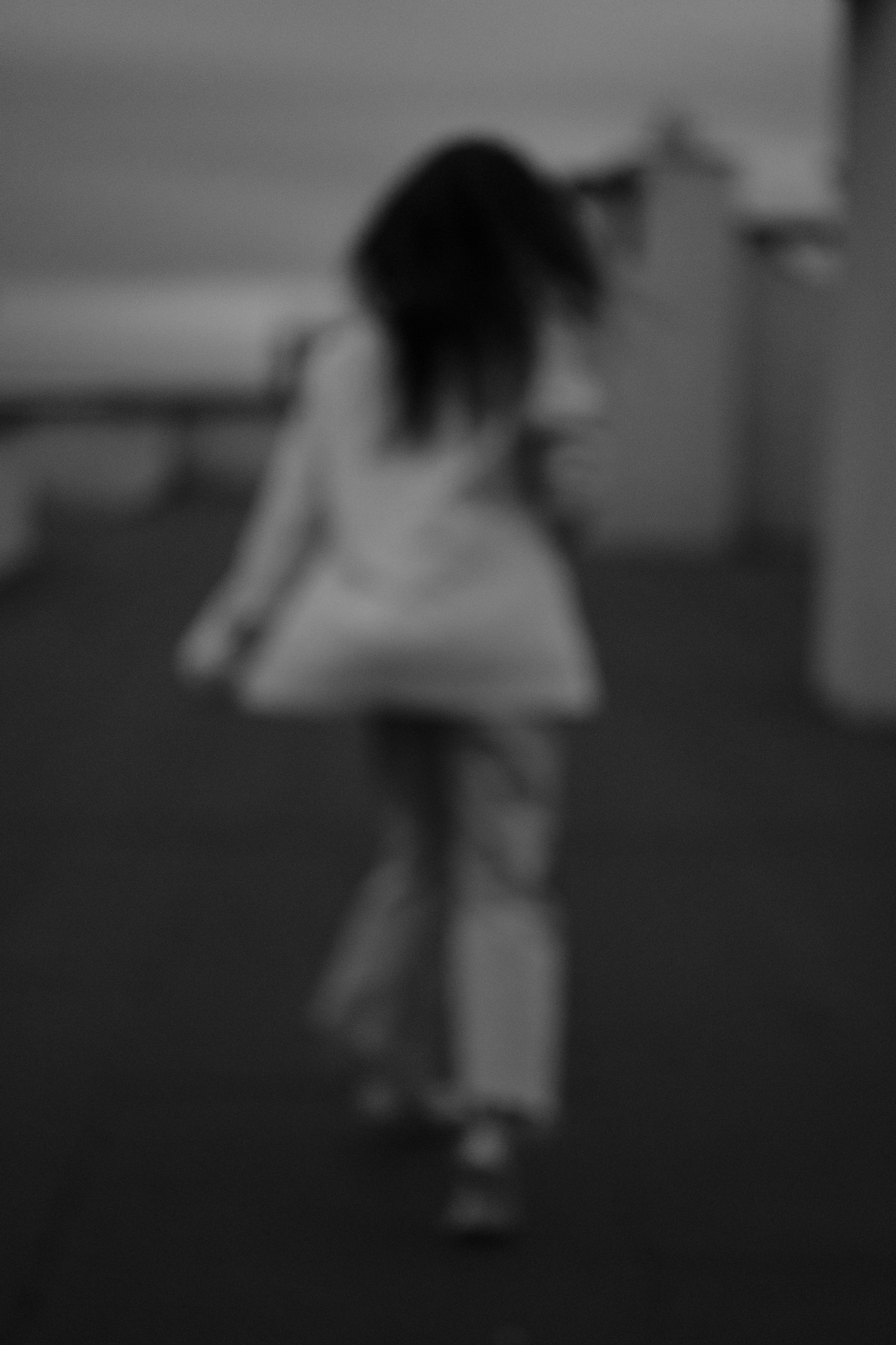 Blurry View of Woman in Dress Standing