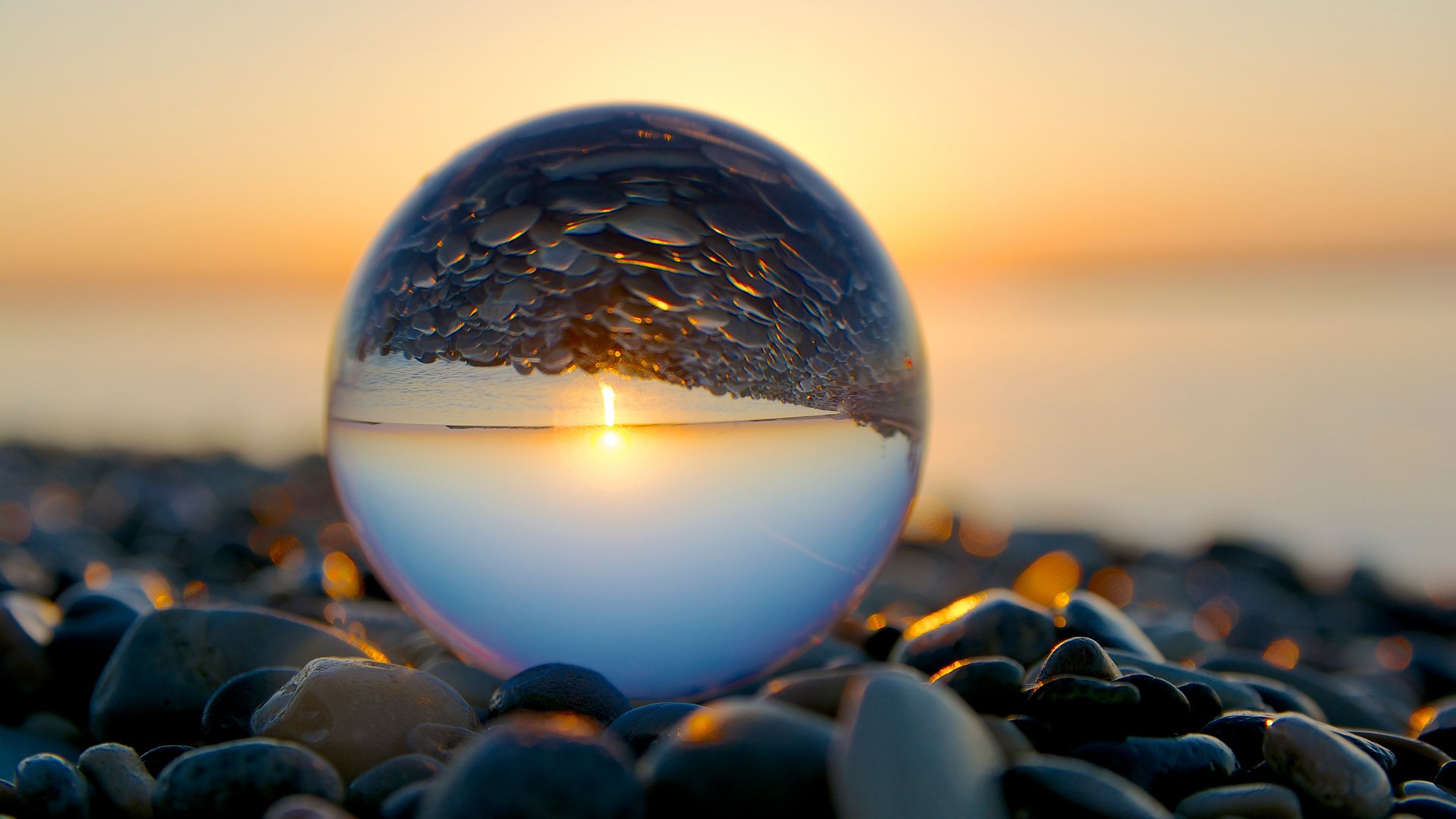 Morning art with glass ball on pebble