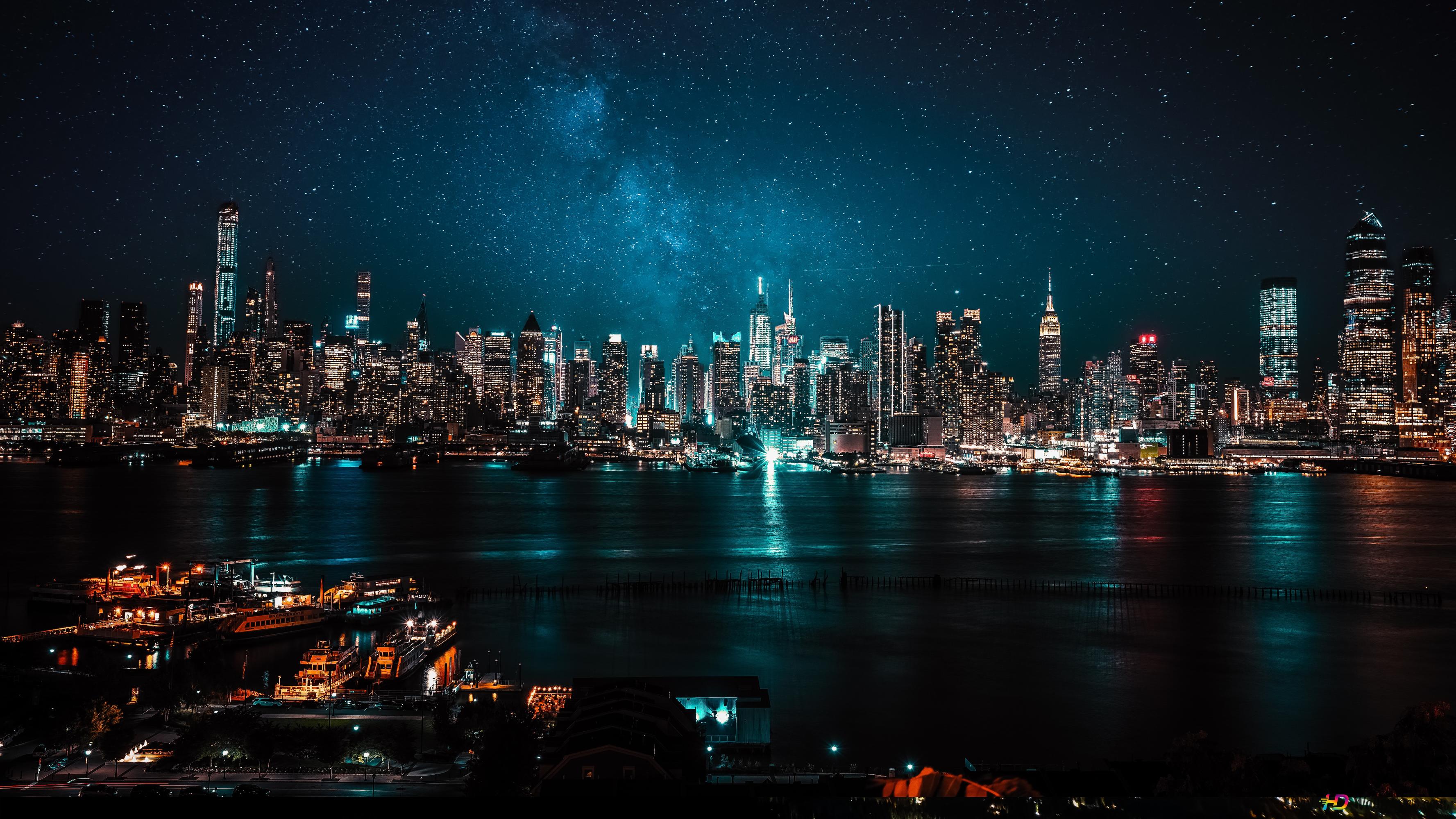 Reflection of building and city lights on the sea in the city taken with long exposure 4K wallpaper download