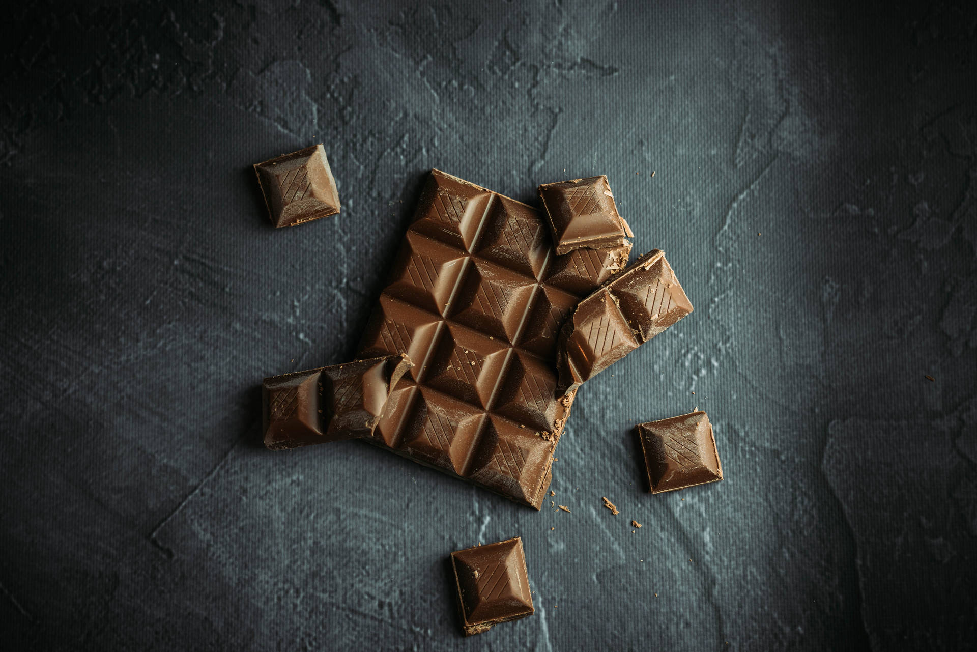 Download Chocolate Squares On Concrete Wallpaper