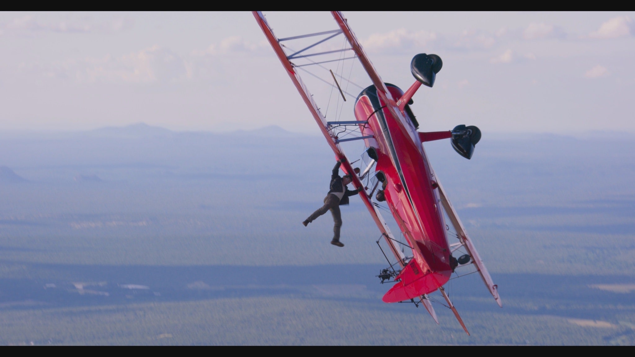 Of course this is Tom Cruise, aged 60, hanging off a plane to film Mission Impossible: Dead Reckoning
