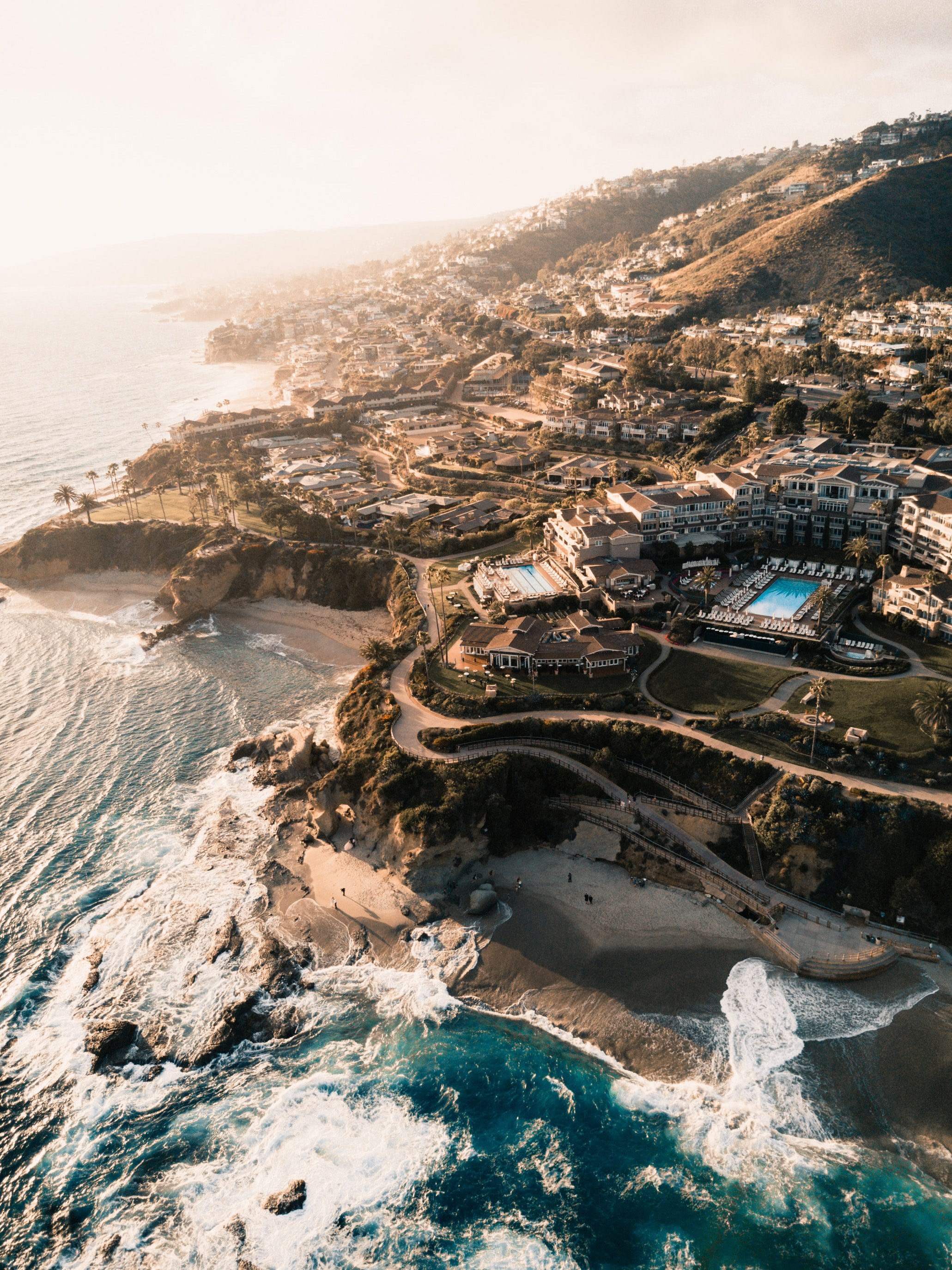 Wallpaper / drone aerial view of the coastal beach resort at laguna beach, coastal resort 4k wallpaper free download