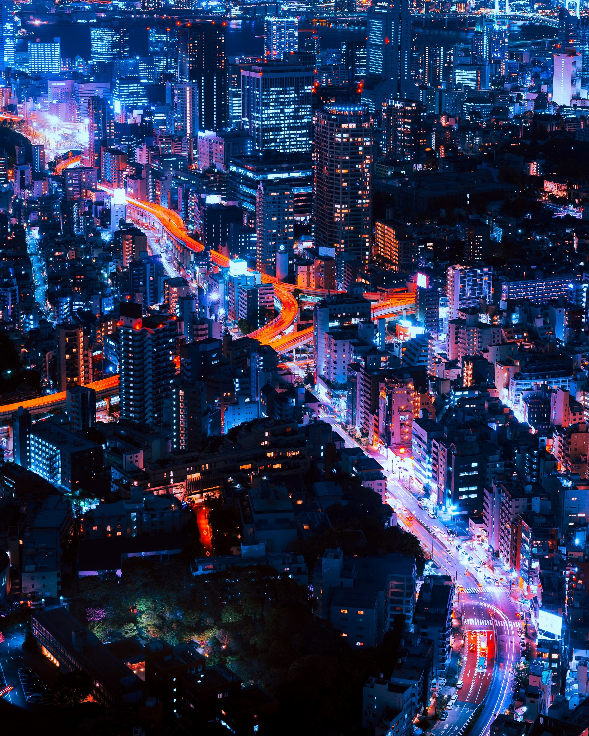 Wallpaper / beautiful skyline of tokyo with orange and blue lights illuminating its streets, tokyo infinity 4k wallpaper free download
