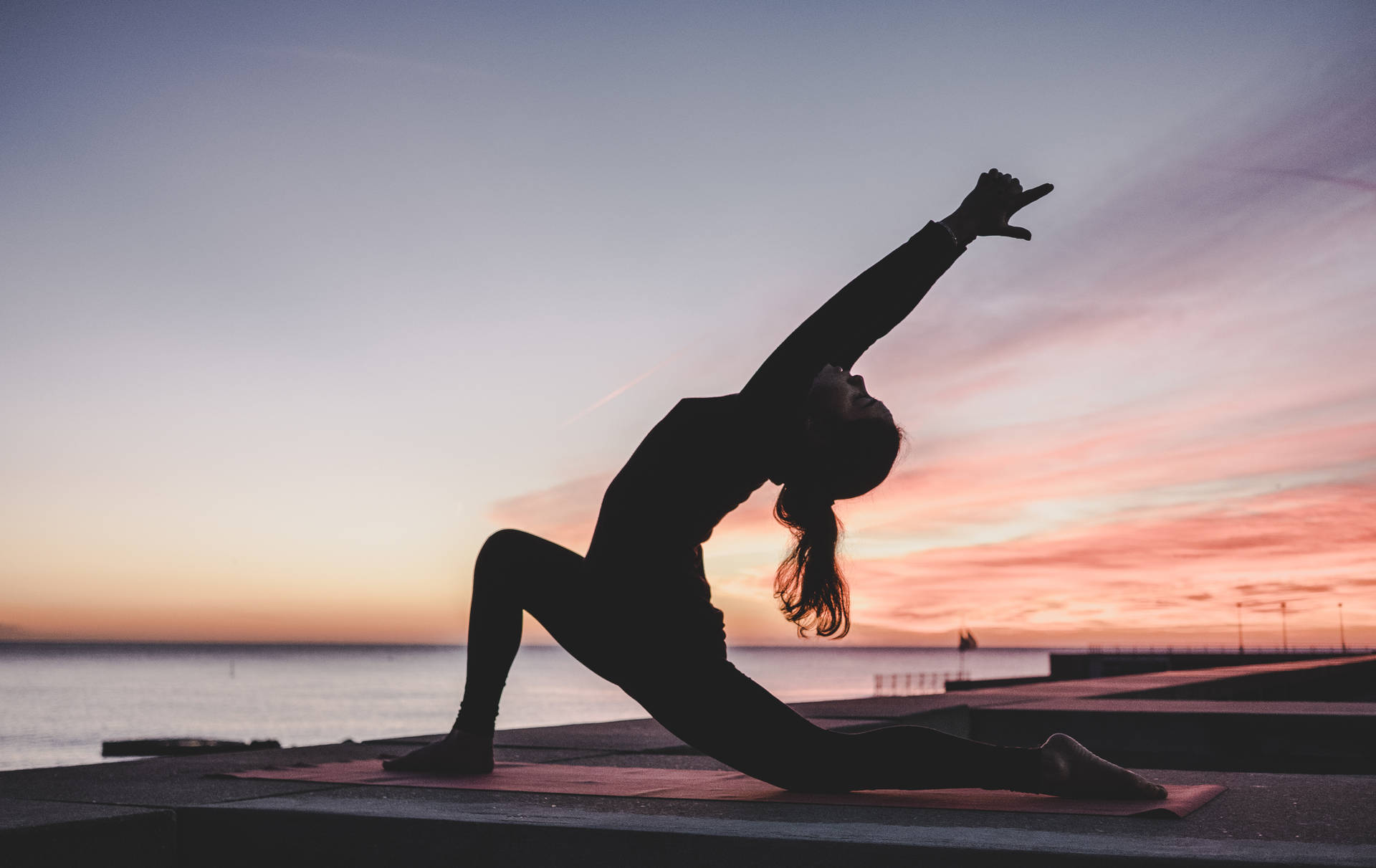 Download Stretching in the shade for an improved fitness routine. Wallpaper