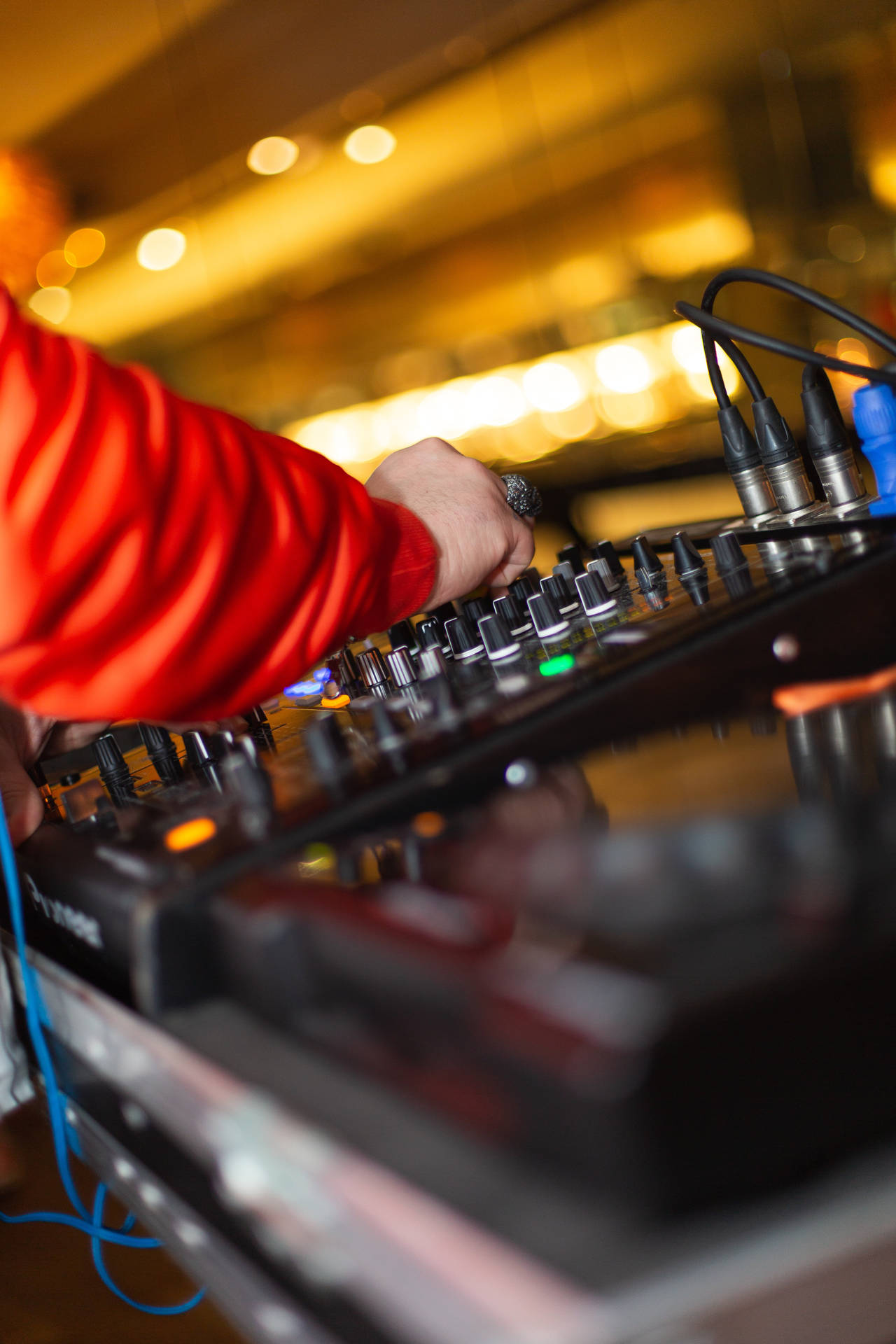 Download DJ skillfully mixing tunes on advanced equipment Wallpaper