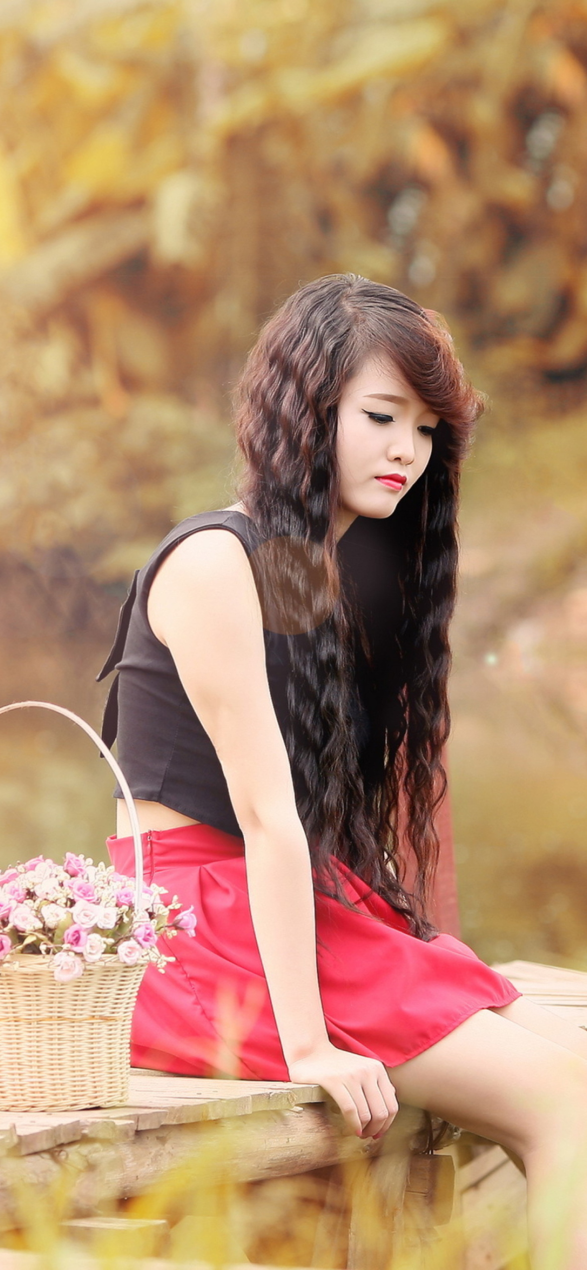 Sad Asian Girl With Flower Basket Wallpaper for iPhone 12 Pro