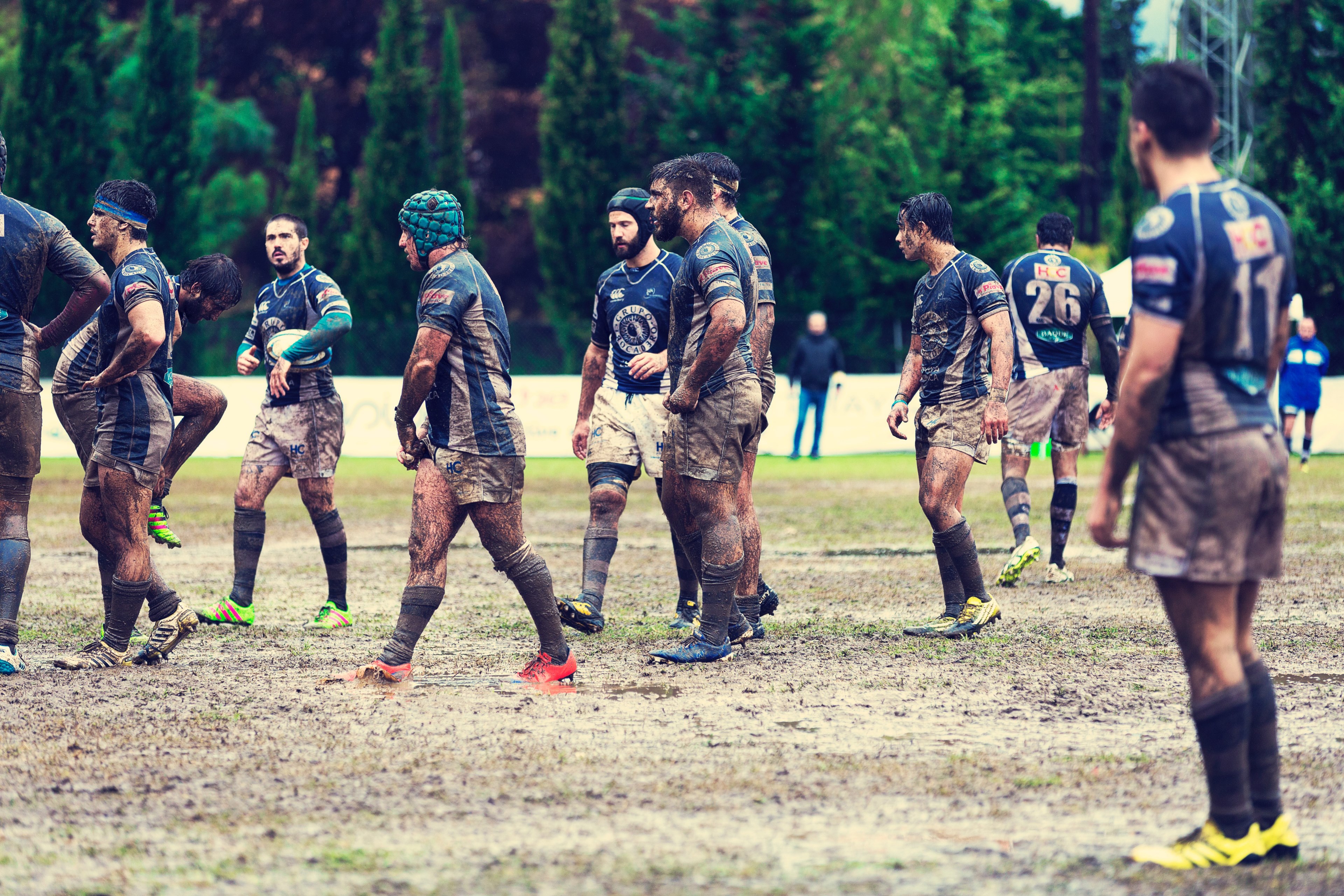 Wallpaper / a male rugby team covered in dirt and mud on a field during a game, rugby 4k wallpaper free download