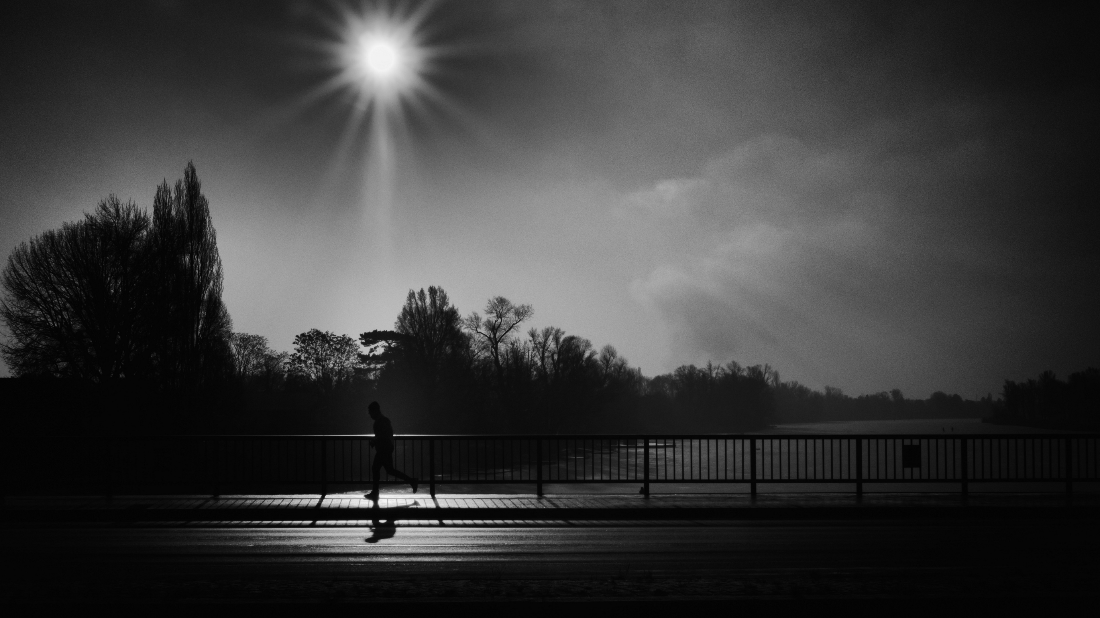 Wallpaper 4k silhouette, running, bridge, bw, sunlight 4k Wallpaper