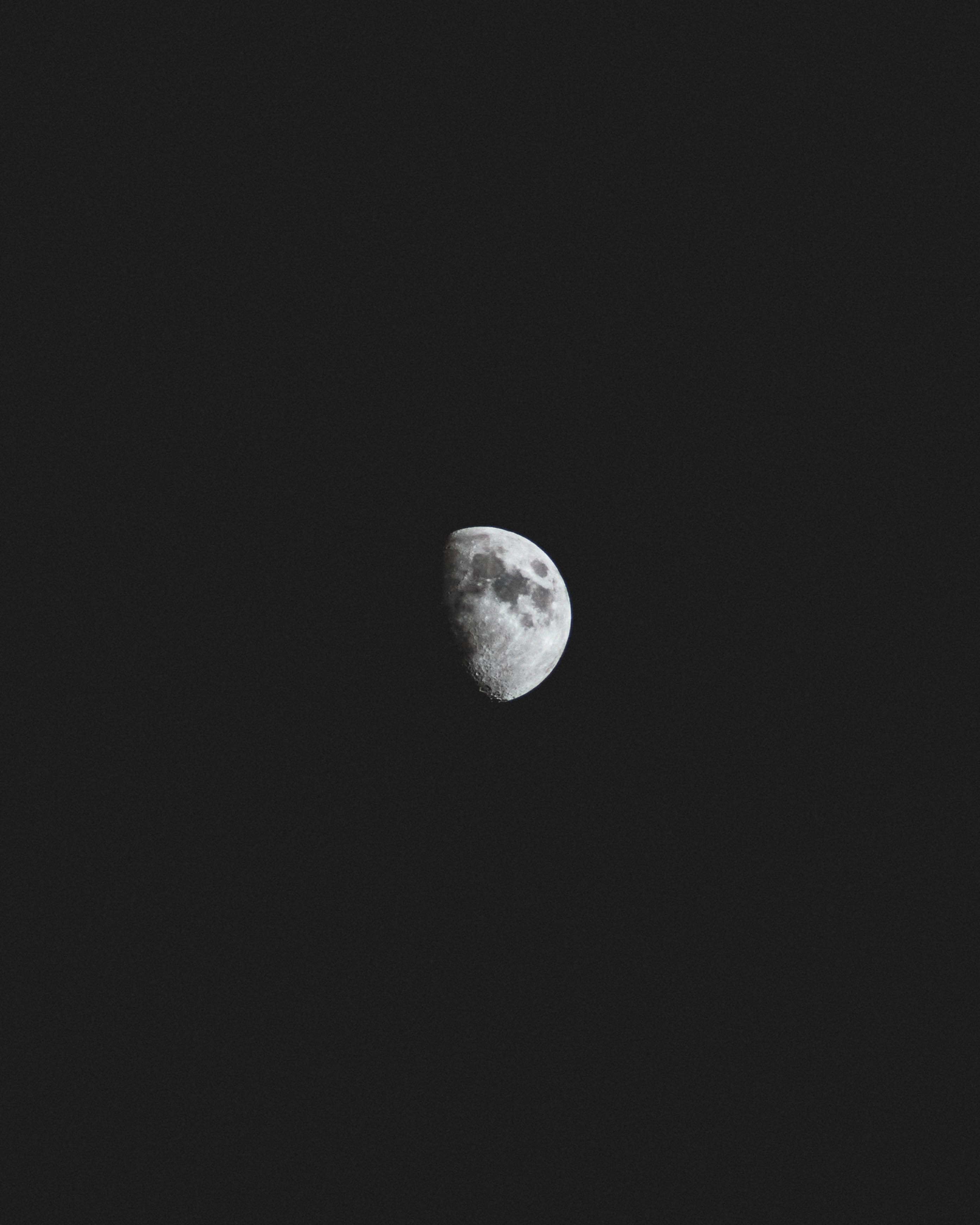 Wallpaper / dark spots visible on a half moon against a black night sky, beyond 4k wallpaper free download