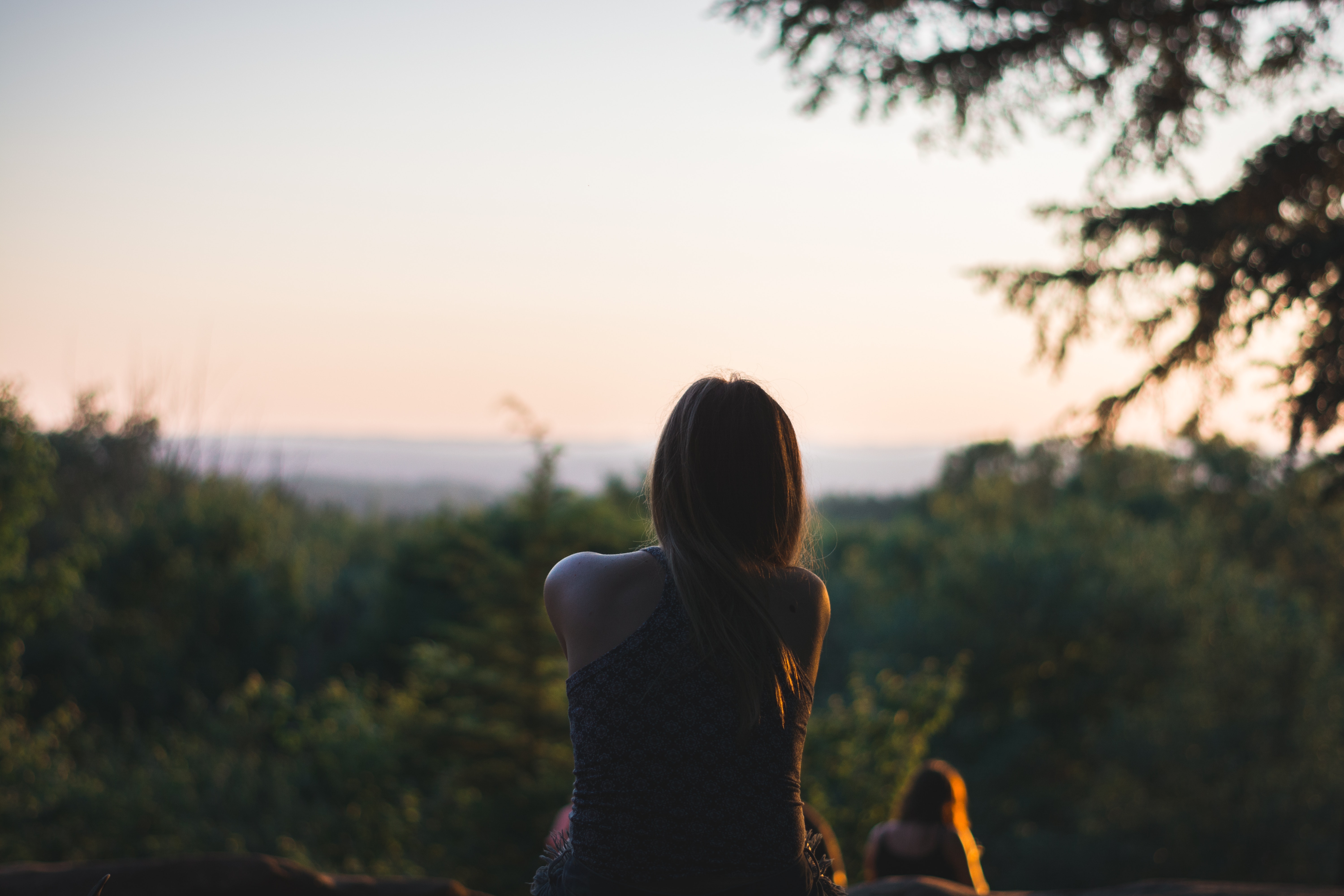 Woman Wearing Black Sleeveless Top in Front of Green Leaf Trees · Free