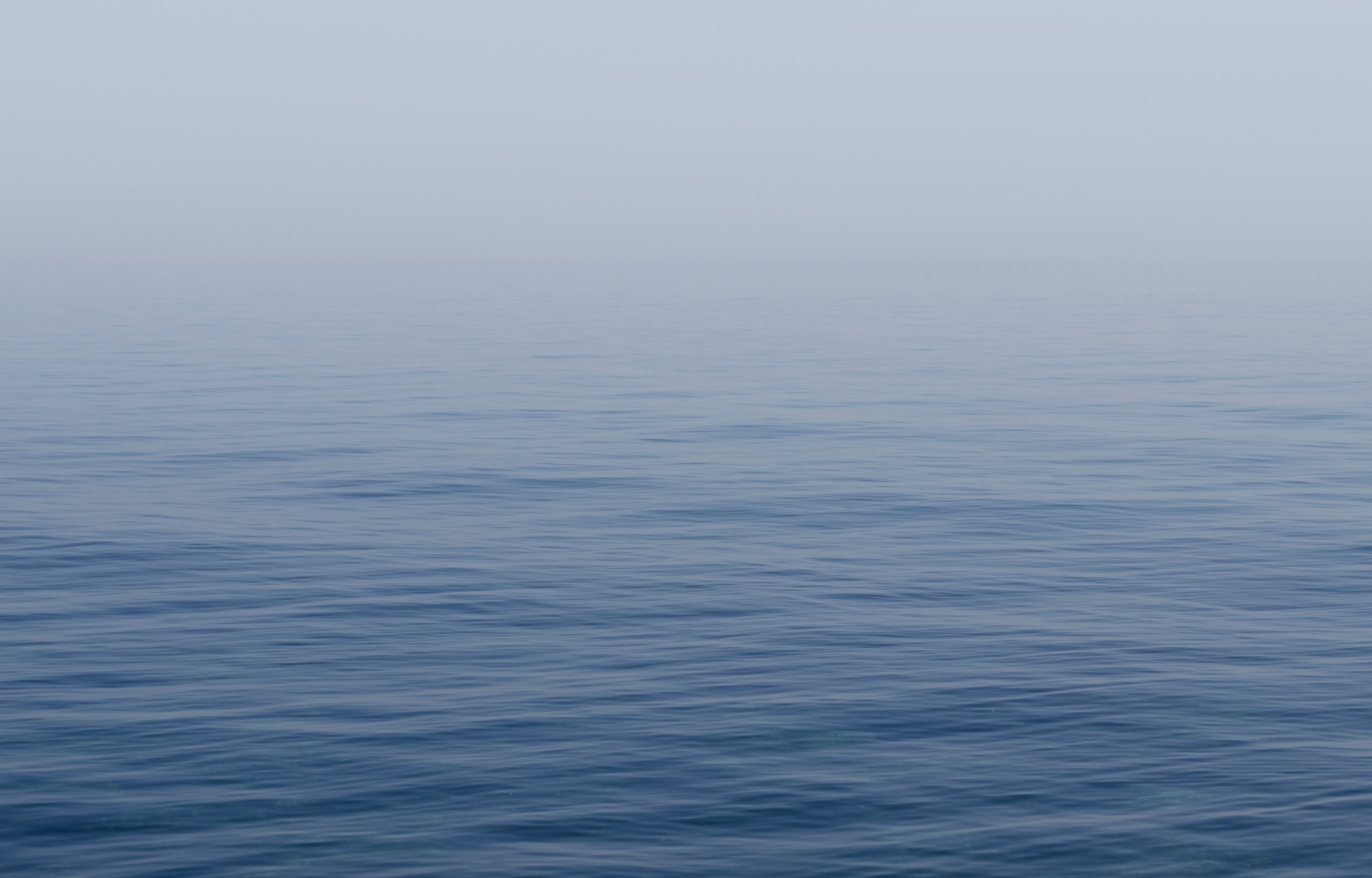 Wallpaper / calm blue sea covered in a soft mist, soft sea mist 4k wallpaper free download