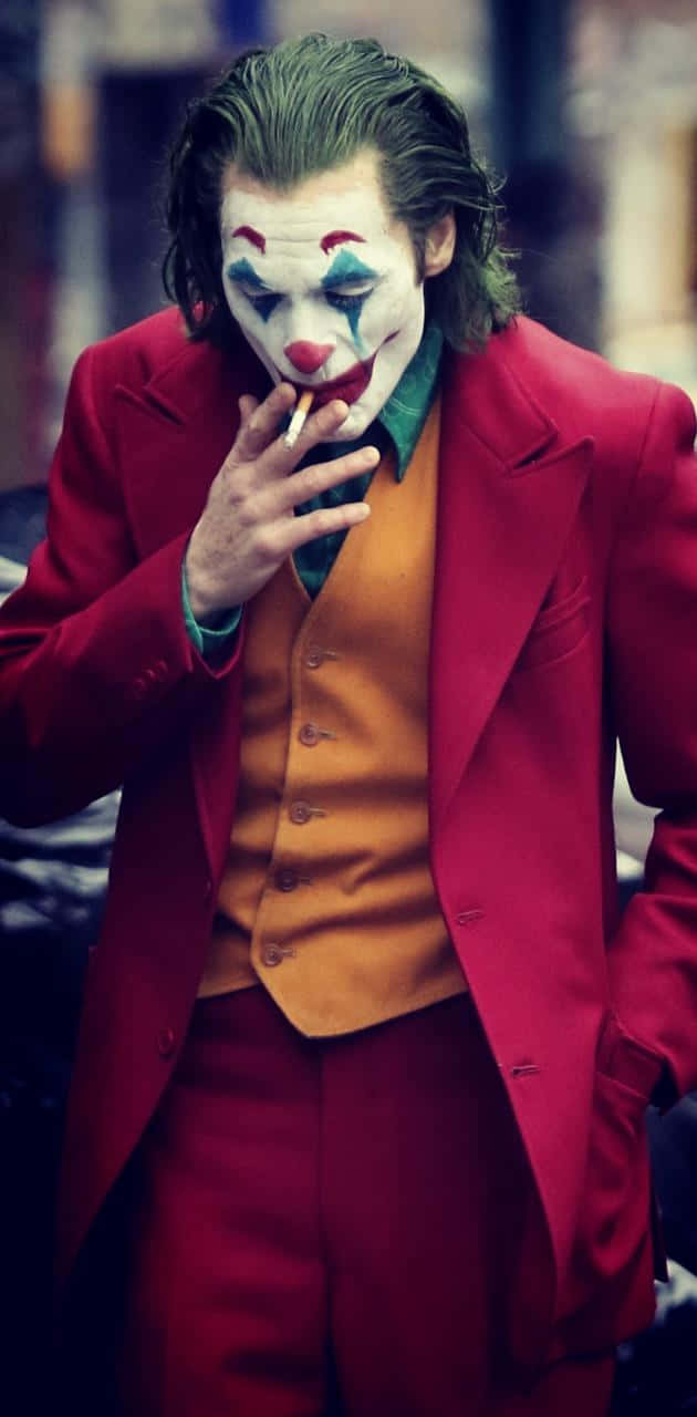 Download Smoking Joker Pfp In Red Suit Wallpaper