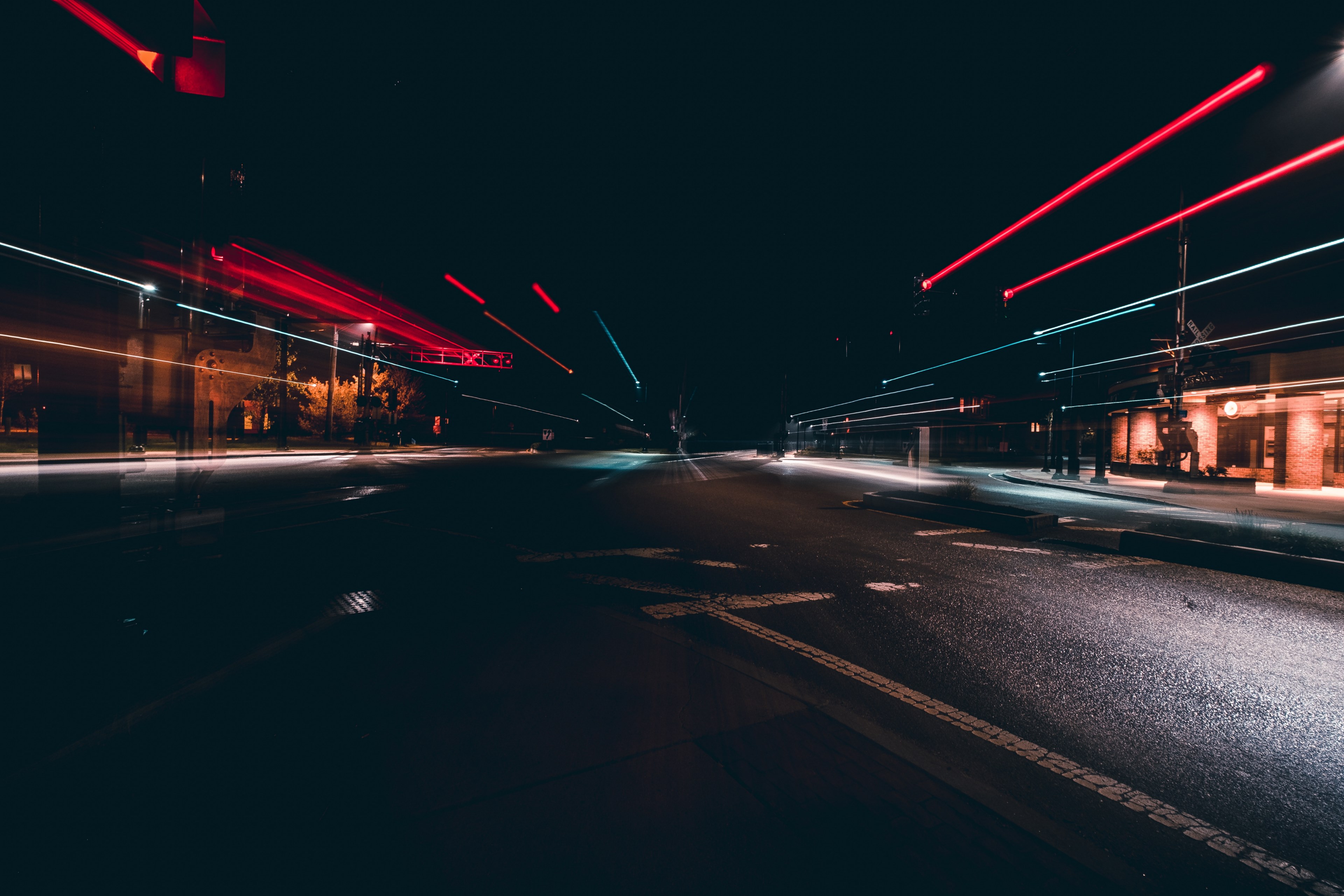 Wallpaper / a long exposure shot of a dark empty road with motion trails, night road in long exposure 4k wallpaper free download