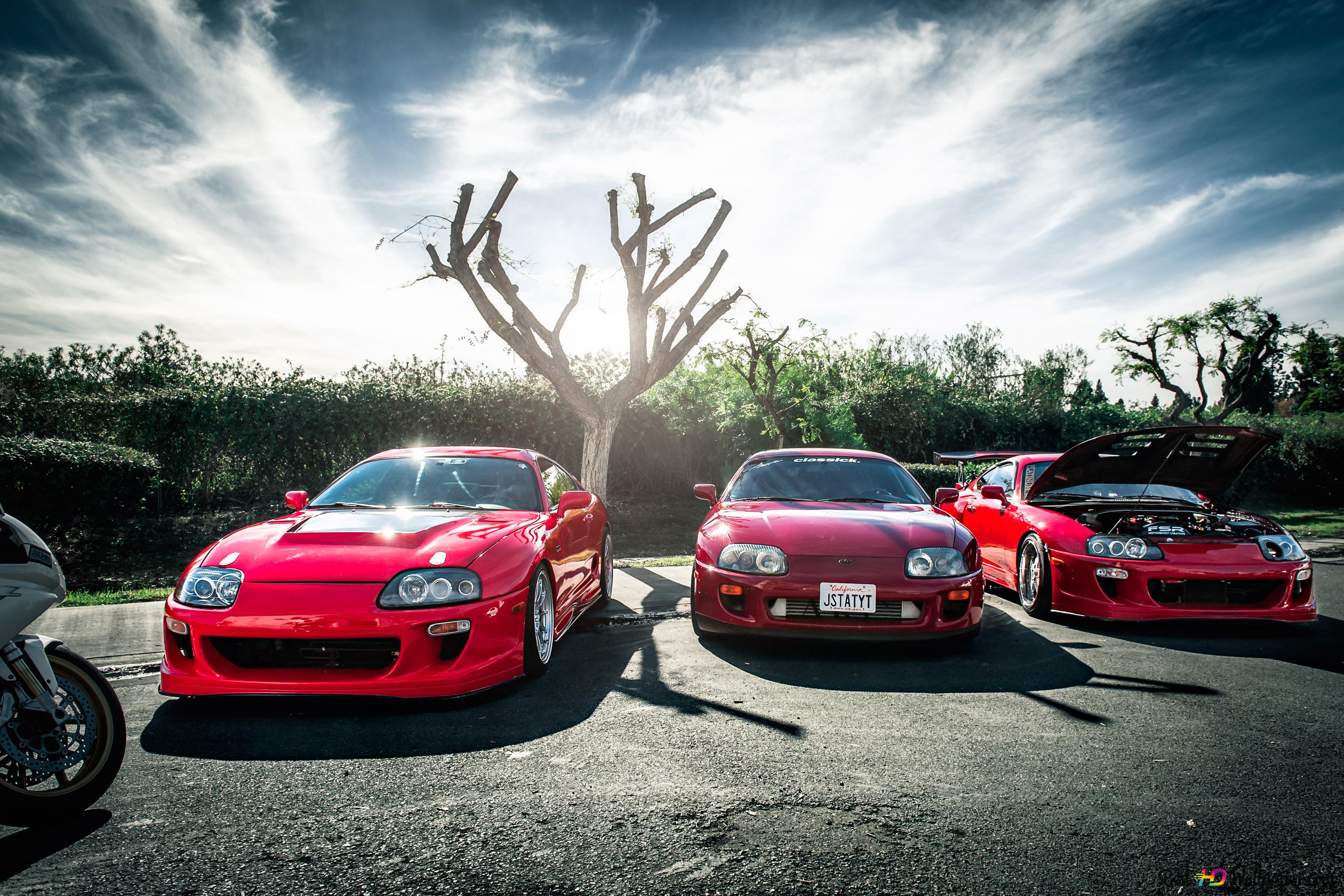 Red Toyota Supra cars under trees in nature 4K wallpaper download