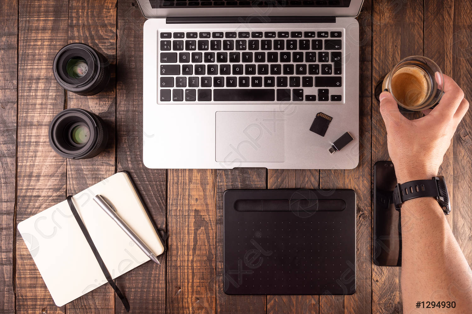 Top view of wooden desktop with laptop, table, coffee, notebook