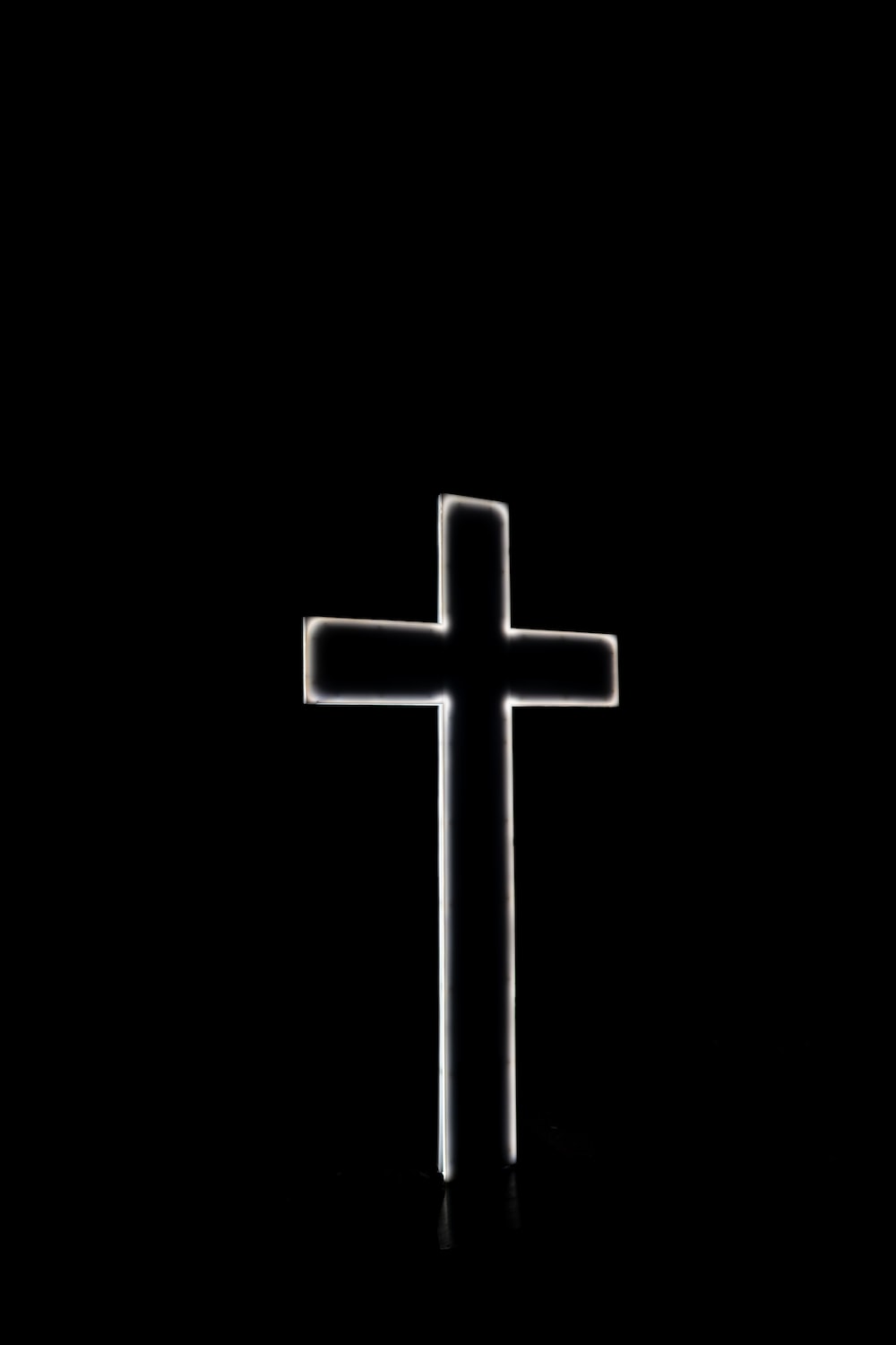 White cross with black background photo