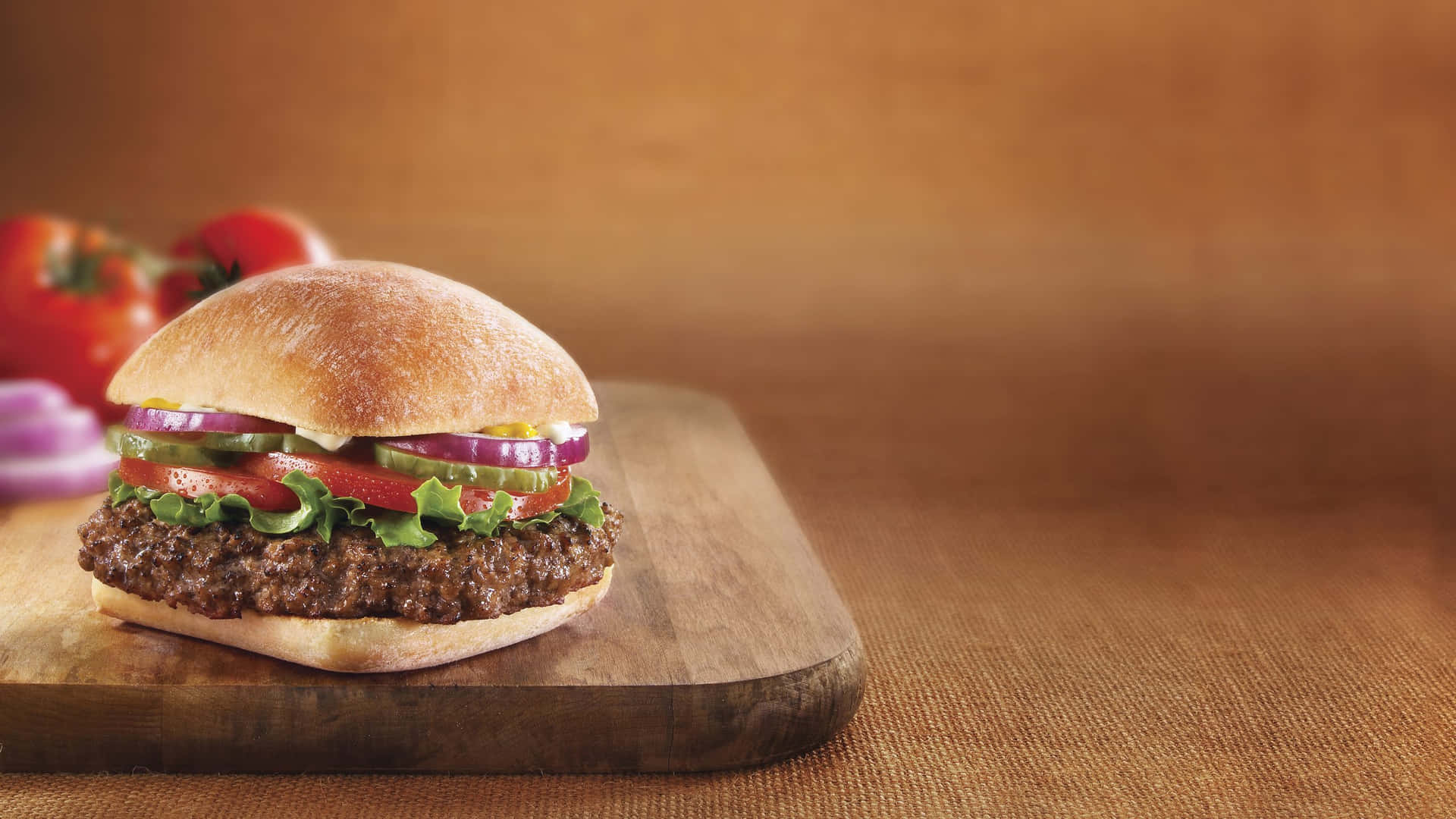 Download Delicious Gourmet Burger on a Rustic Setting