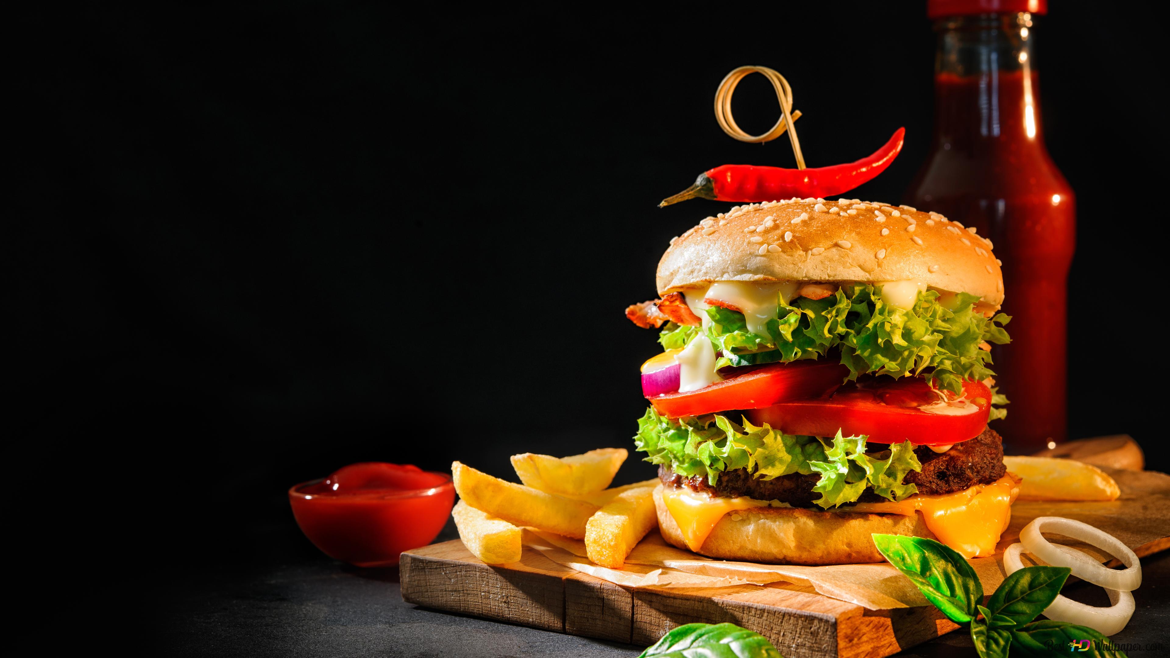 Overloaded burger with fries and a bottle of ketchup 4K wallpaper download