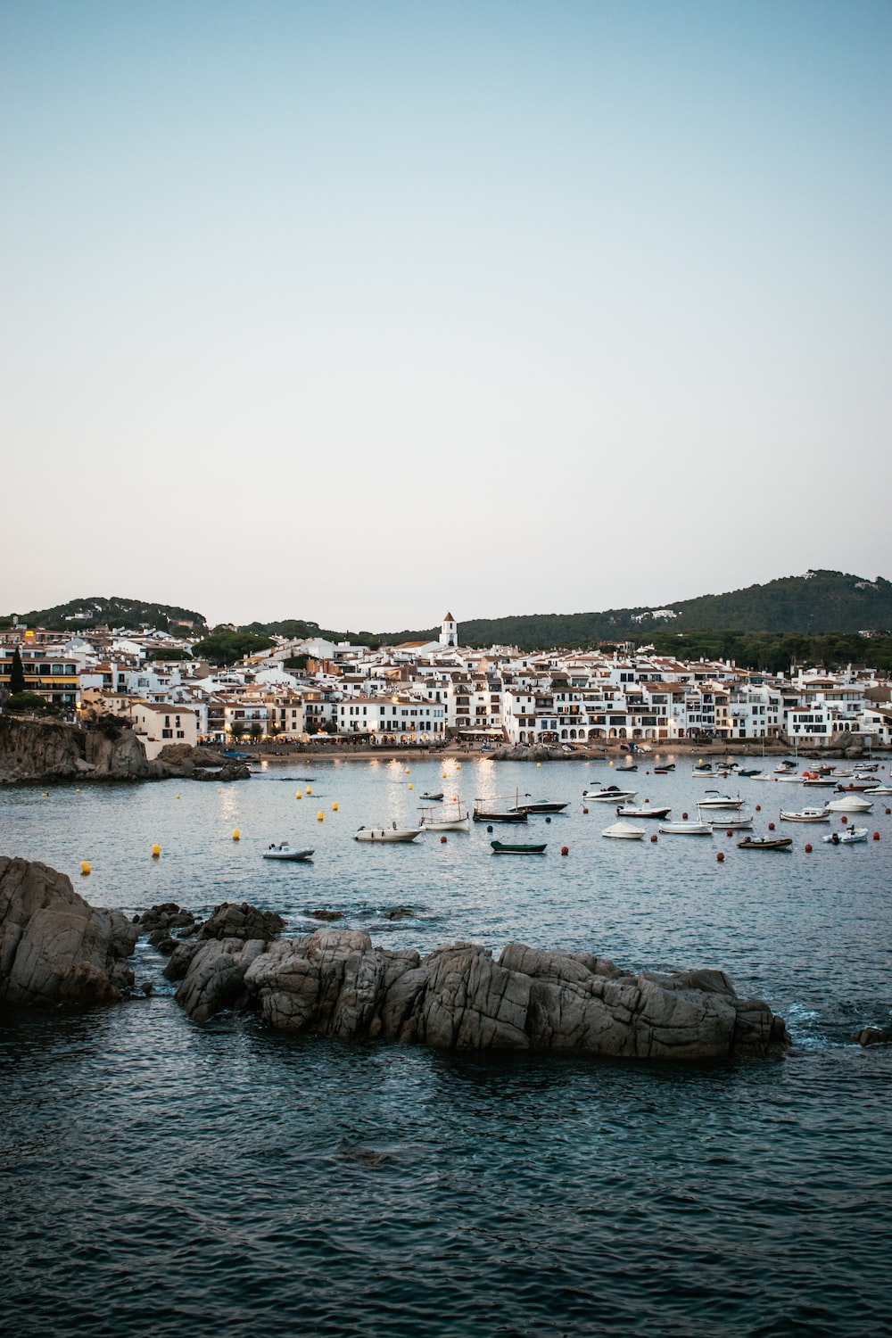 A harbor filled with lots of boats on top of a body of water photo